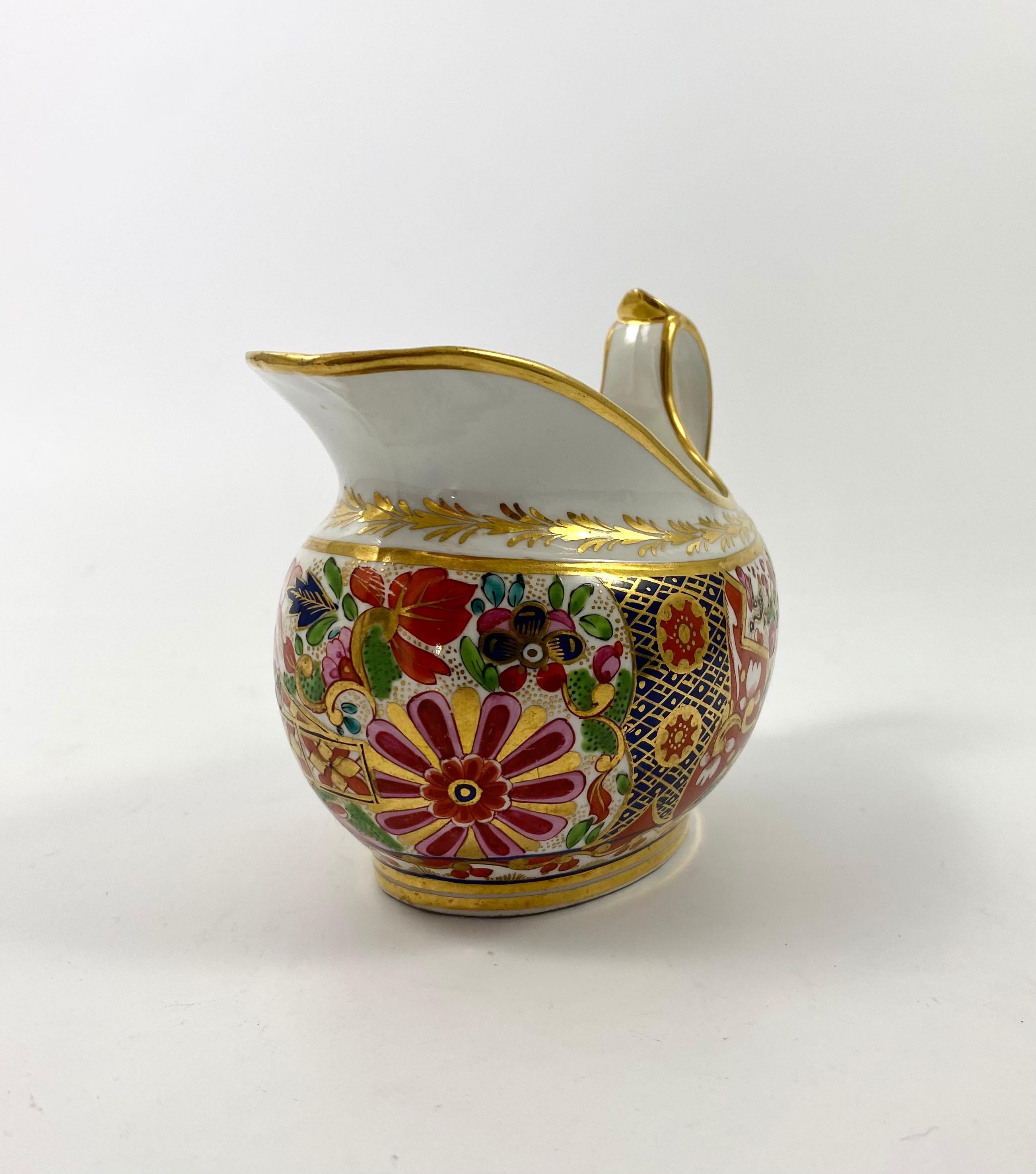Barr, Flight and Barr Worcester porcelain cream jug, c. 1815. Finely hand painted in vibrant enamels, and gilding, with a rich Imari pattern, of a profusion of flowers growing in a garden. The spout with a stylised flowerhead in gilt.
Impressed