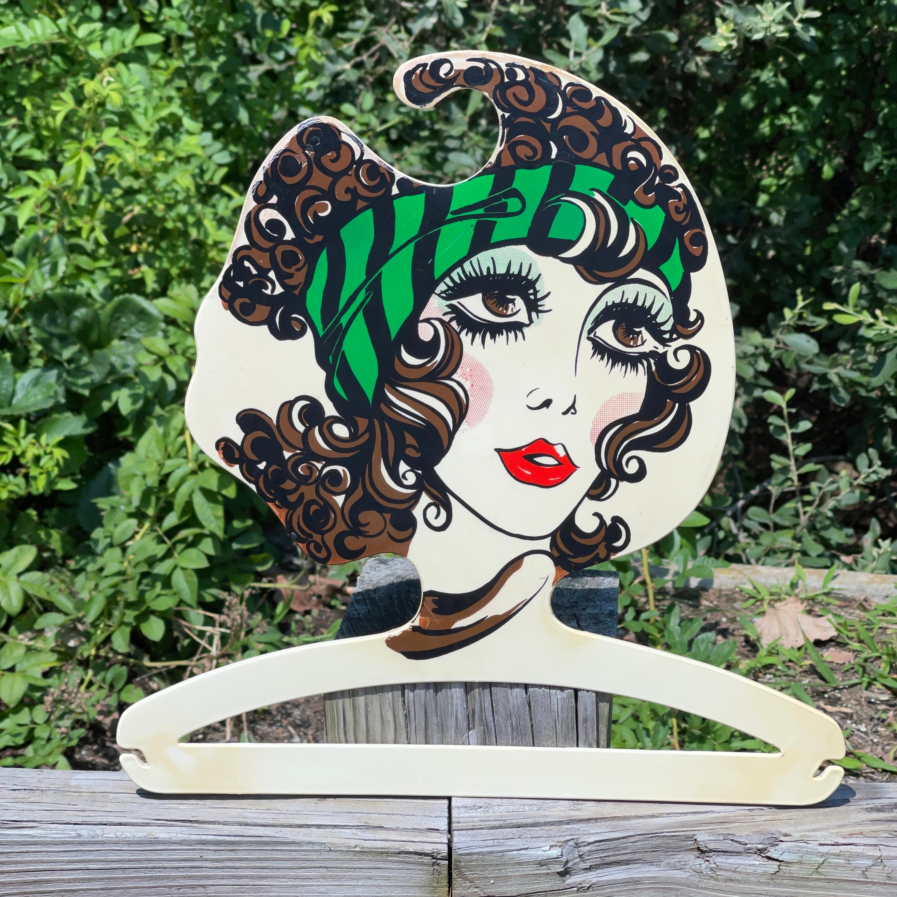 1960's Italian plastic coat hanger with stylized head and face of a fashionable young woman applied via lithograph transfer.
Produced in Italy by BG Milano (No relation but I love the sound of it!)
Alas, we have just this one but continue to hunt