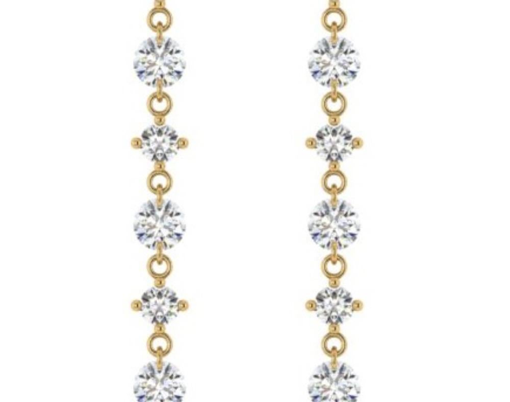 From the Bhansali Air collection, these simple and sophisticated 18kt yellow gold long earrings feature a laser drilled diamond (3.27 cts)  dangle. What makes this piece so unique is that the diamond has no setting, which means no prongs! The