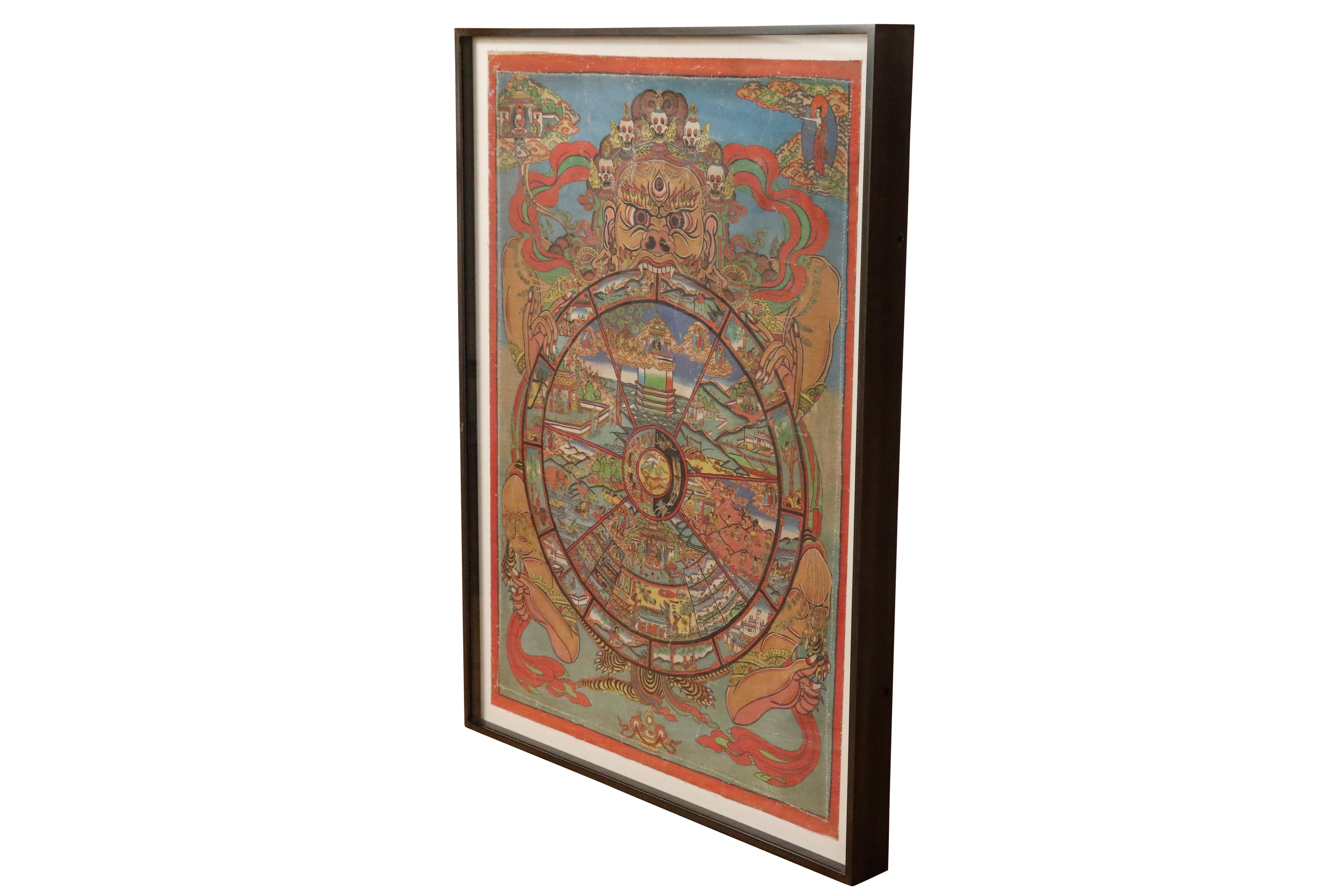 A framed Tibetan Buddhist thangka (a painted wall hanging) of Bhavacakra. Depicts Samsara, the 
