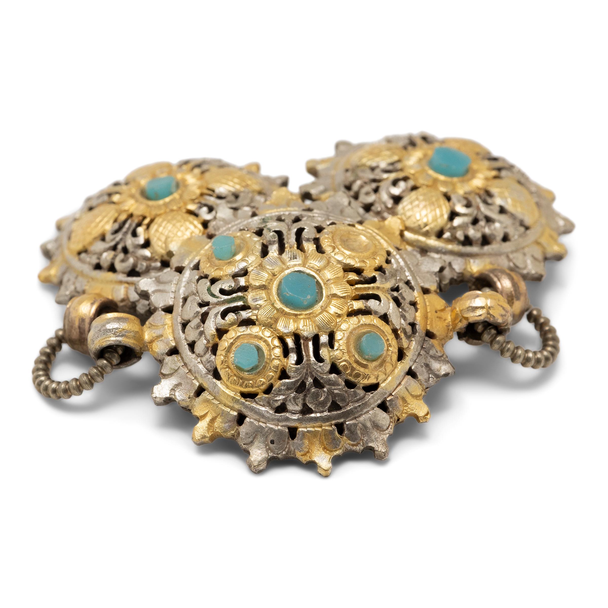 These openwork cast alloy brooches are a contemporary example of Bhutanese cloak fasteners known as koma. Worn by women to secure a traditional garment known as kira, the fasteners were secured to one's clothing by simple hooks affixed to the backs
