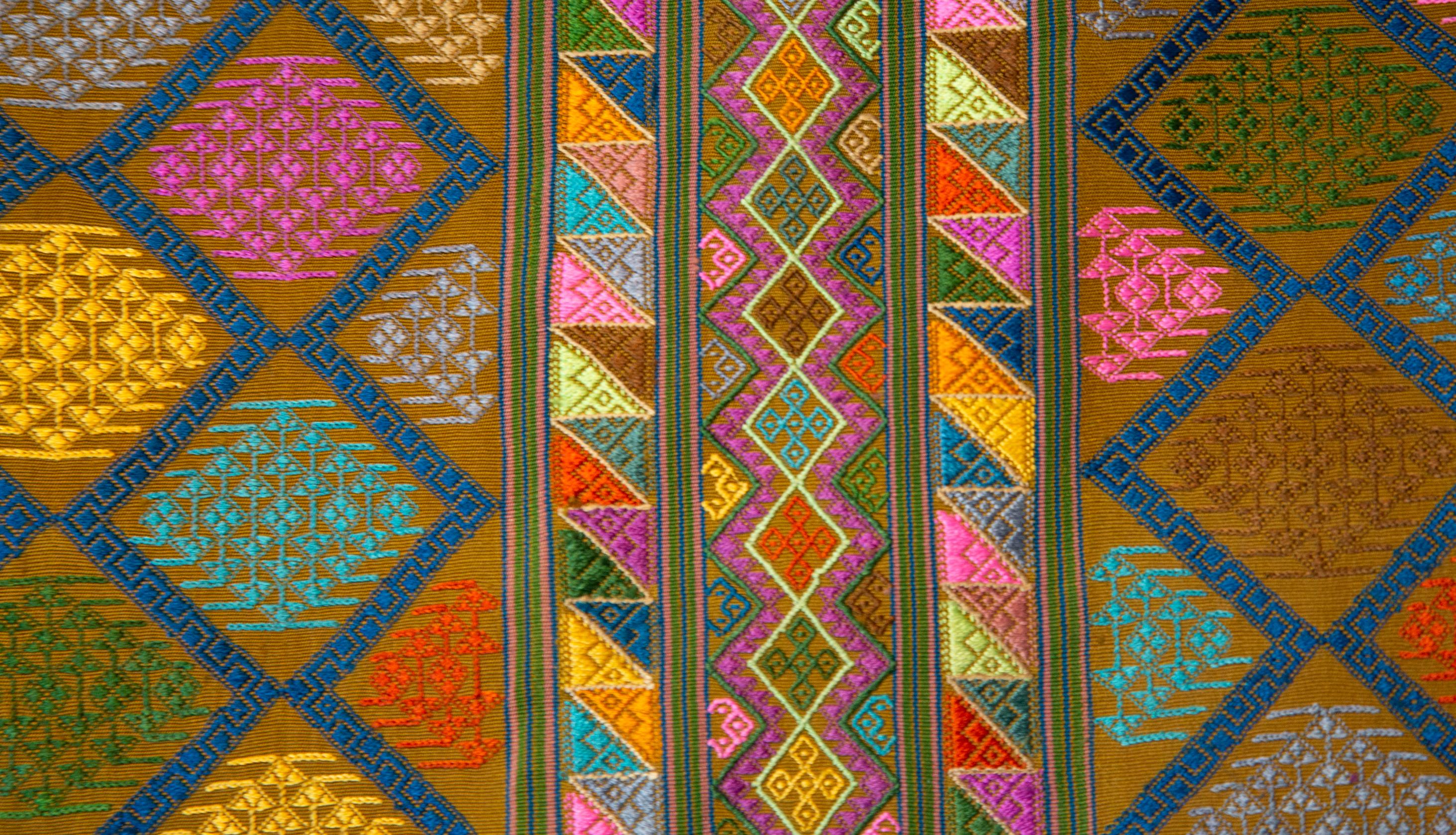 Bhutanese silk woven Kira textile, purple. From the royal weavers of Bhutan, this Kira textile is a rectangular weaving worn as an ankle length dress by Bhutanese women. This example was originally woven for Her Majesty Gyalyum (Queen Mother) Sangay
