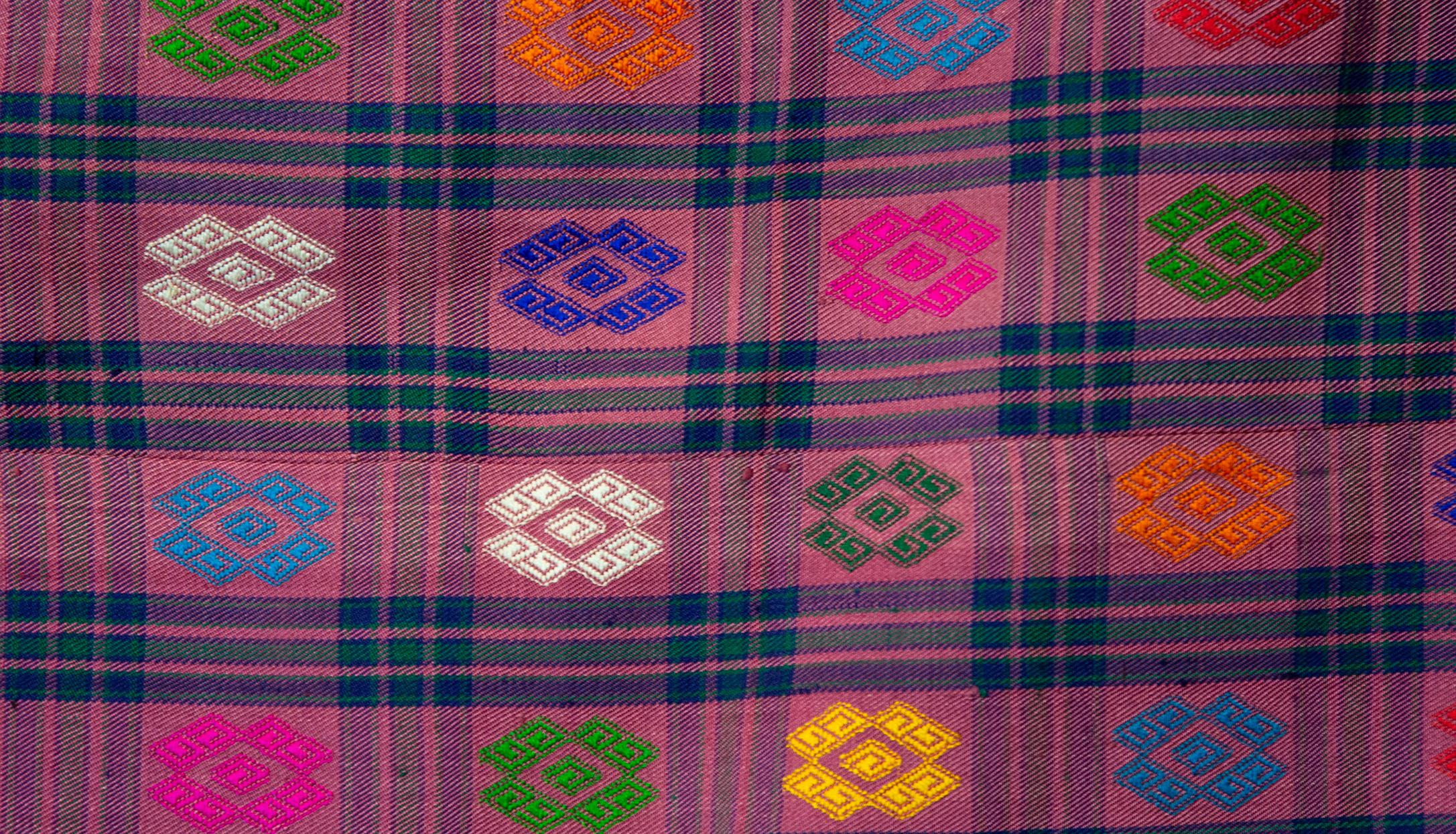 Bhutanese silk woven Kira textile, purple. From the royal weavers of Bhutan, this kira textile is a rectangular weaving worn as an ankle length dress by Bhutanese women. This example was originally woven for Her Majesty Gyalyum (Queen Mother) Sangay