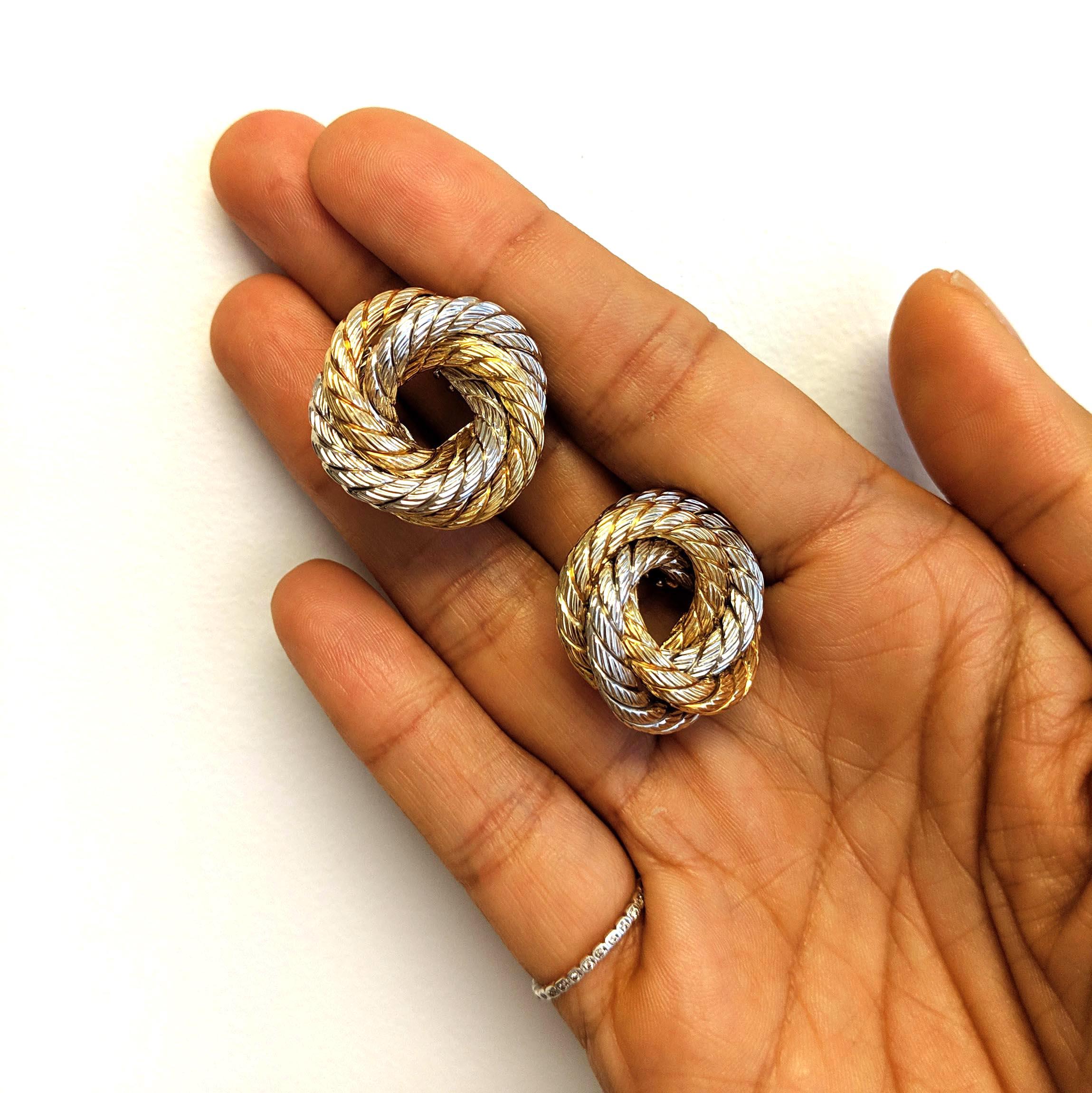A torsade swirl design featuring contrasting white and yellow 18k gold. These earrings do not have posts, but the design does have room to accommodate them. We do not offer this service, but it is an easy request to a jeweler. 

* More photos by