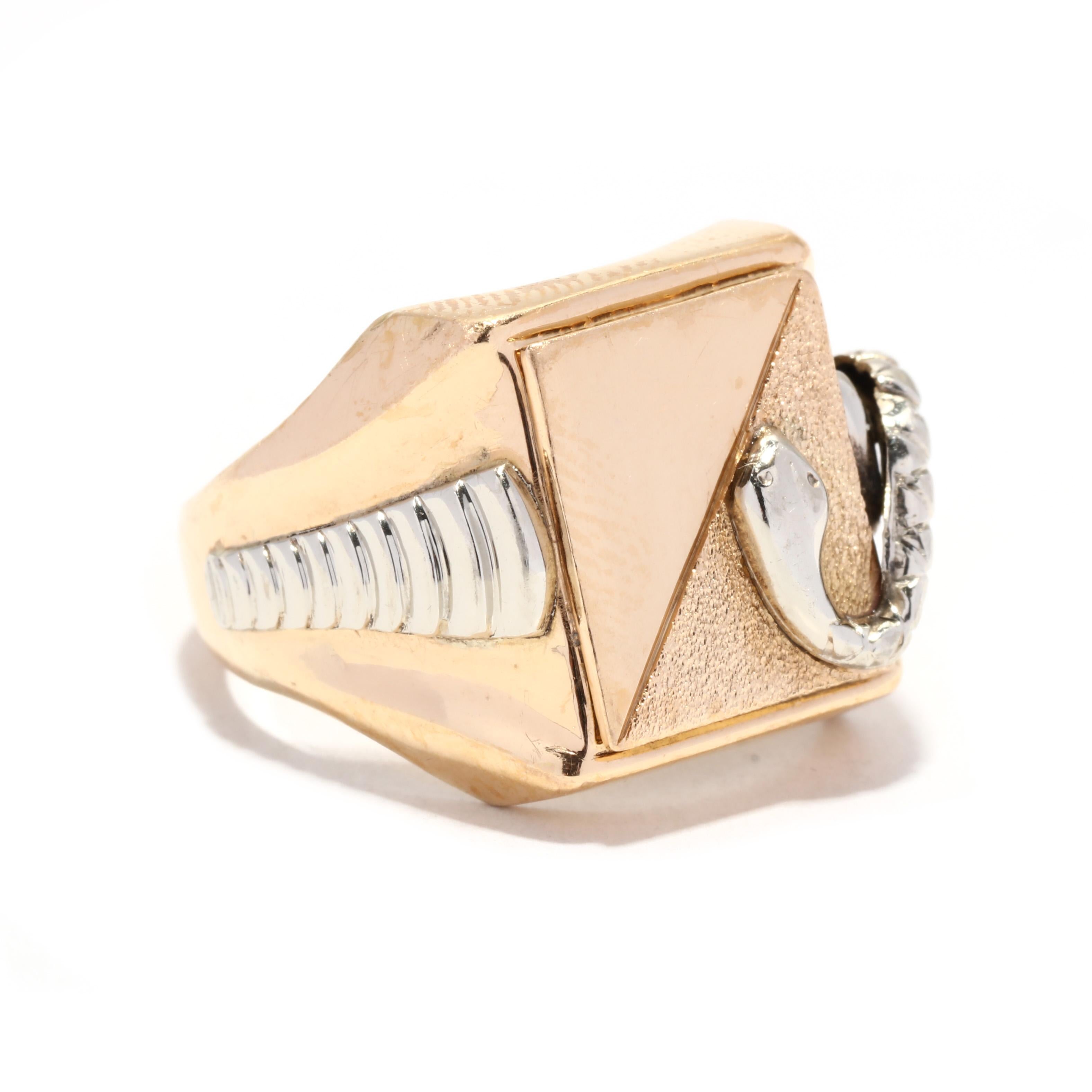 A vintage 18 karat bi color gold rectangular snake signet ring. This large gent's signer ring features a polished and textured finish rectangular face with a white gold snake motif coiled over the edge on to the tapered band and with white gold