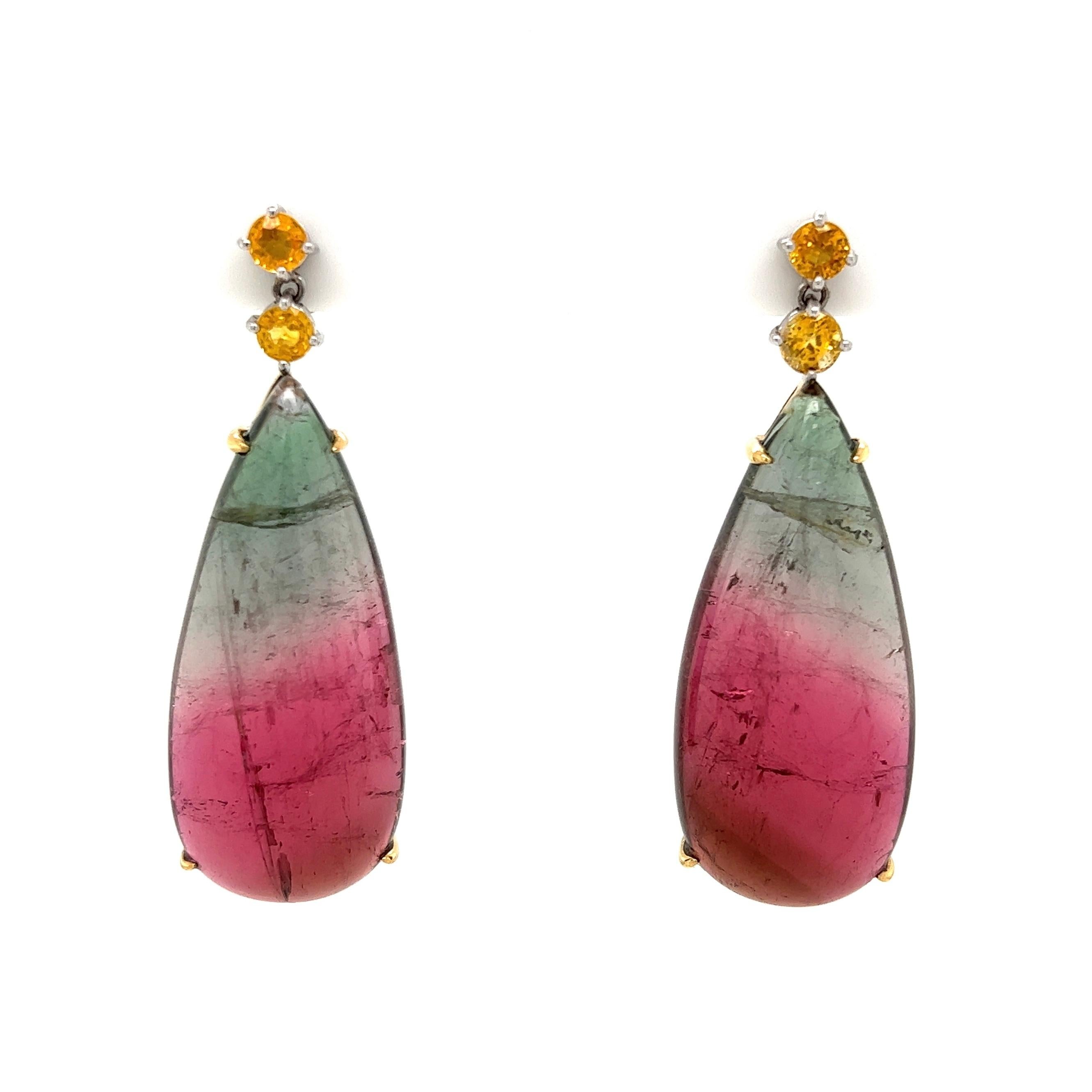 Beautiful pair of Bi-Color 45tcw Tourmaline and 1.20tcw Yellow Sapphire Earrings. Hand crafted 18K Yellow Gold mounting. Approx. Dimensions: 1.75” long x 0.65” wide. More Beautiful in real time...Sure to be admired, a piece you’ll turn to time and