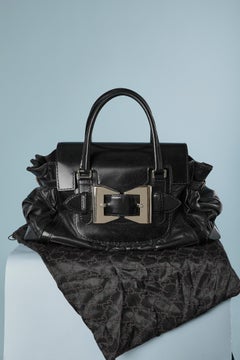 Bi-leather top handle bag with silver metal buckle on the front GUCCI