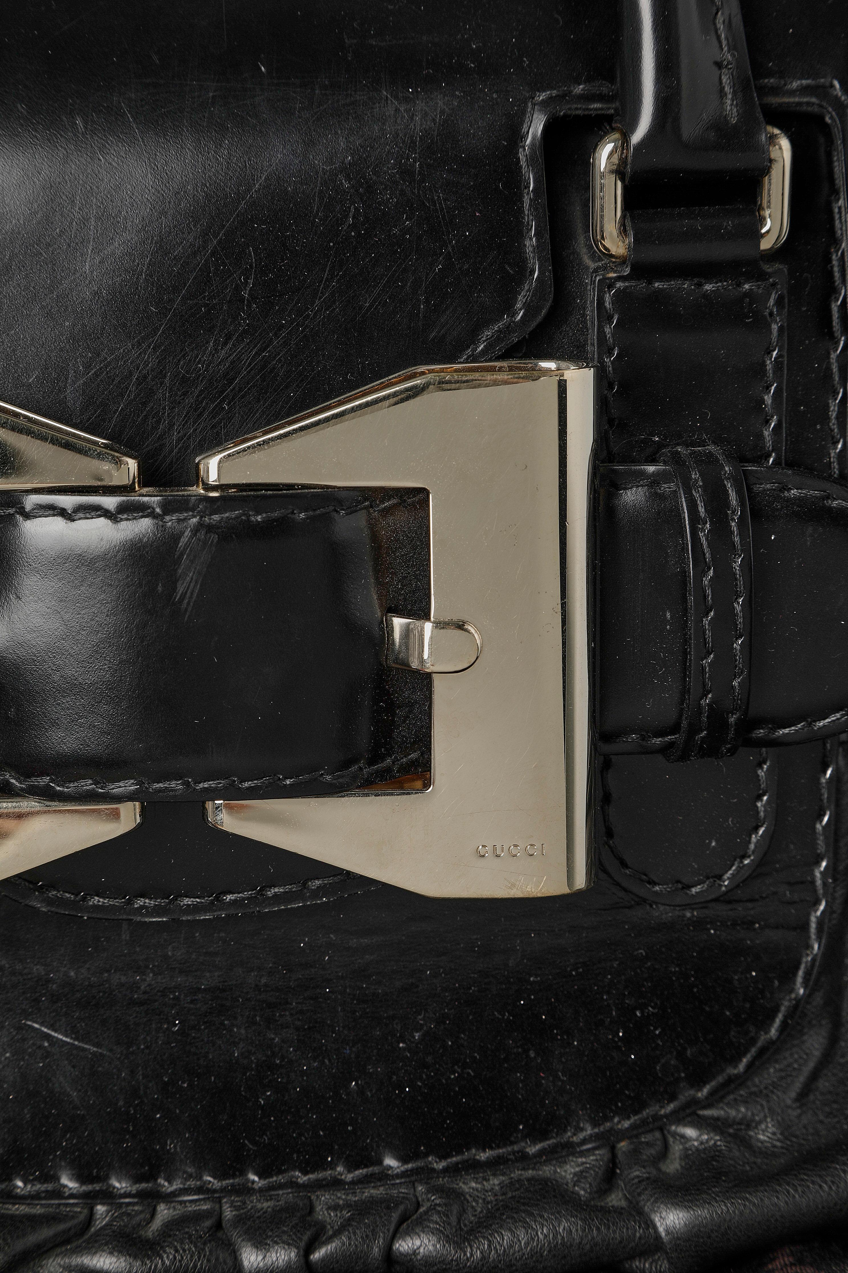 Black Bi-leather top handle bag with silver metal buckle on the front GUCCI For Sale