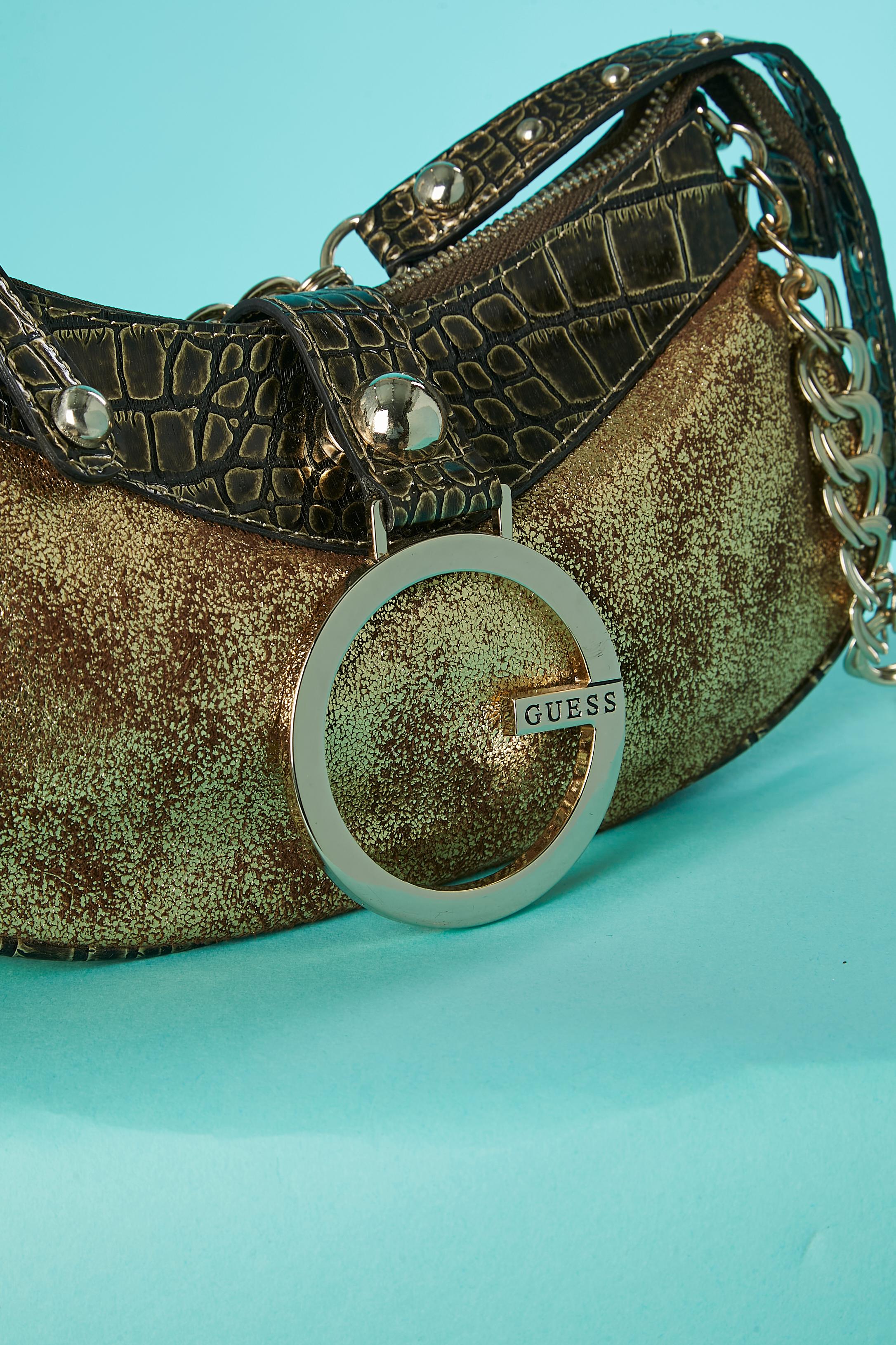 Bi material gold evening bag . Fabric composition: 100% polyester and PVC . Branded polyester lining. 3 pocket inside ( one with zip and 2 flat pocket without zip) 
Zip closure on the top of the bag. 
SIZE : 25cm X 15cm X 4cm
Shoulder lenght = 52cm 