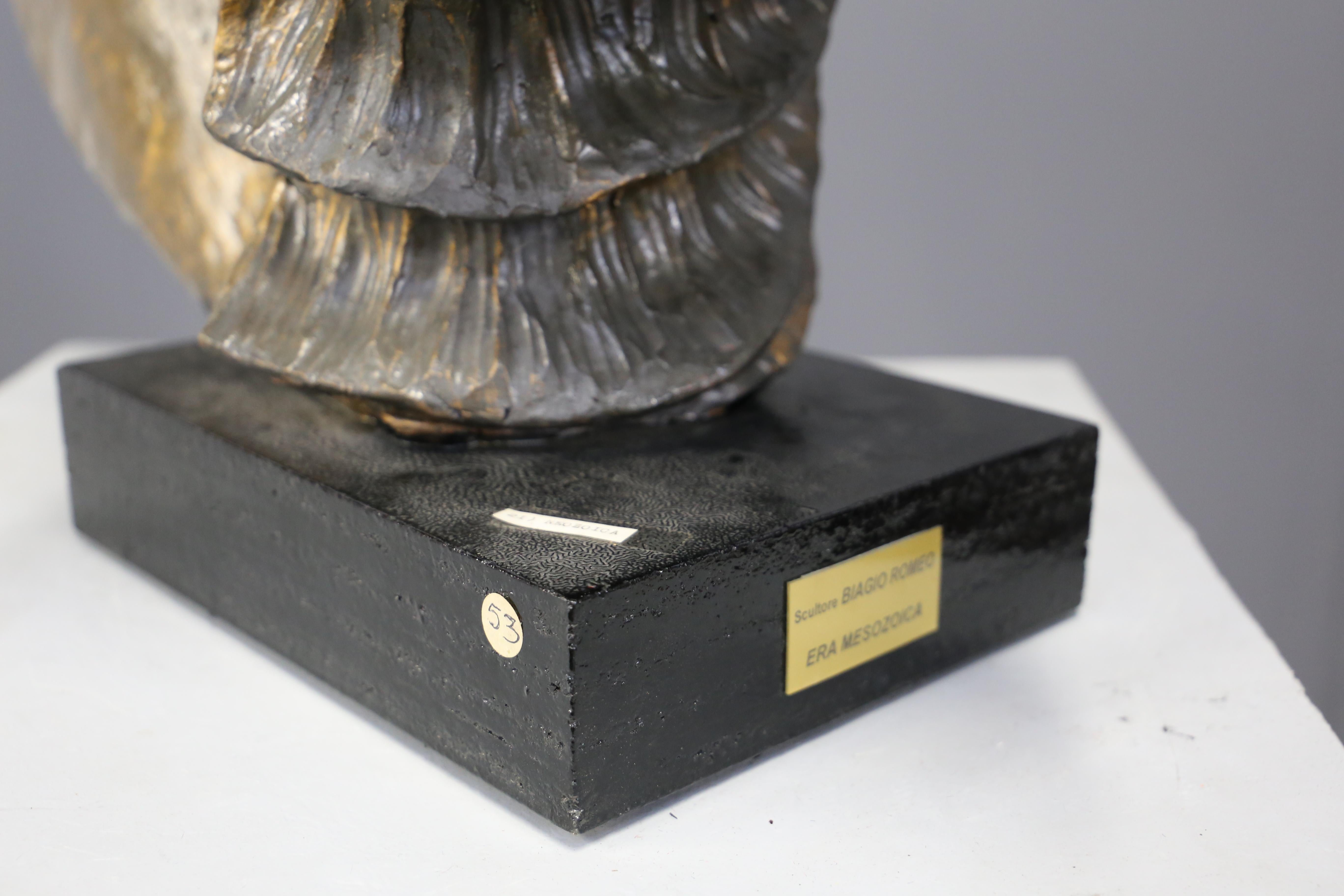 Beautiful bronze and wood sculpture designed in 1995, fine Italian manufacture. Signed.
The base is made of lacquered black wood. This form serves as a pedestal for the actual sculpture.
The main body is a sculpture representing the Mesozoic era,