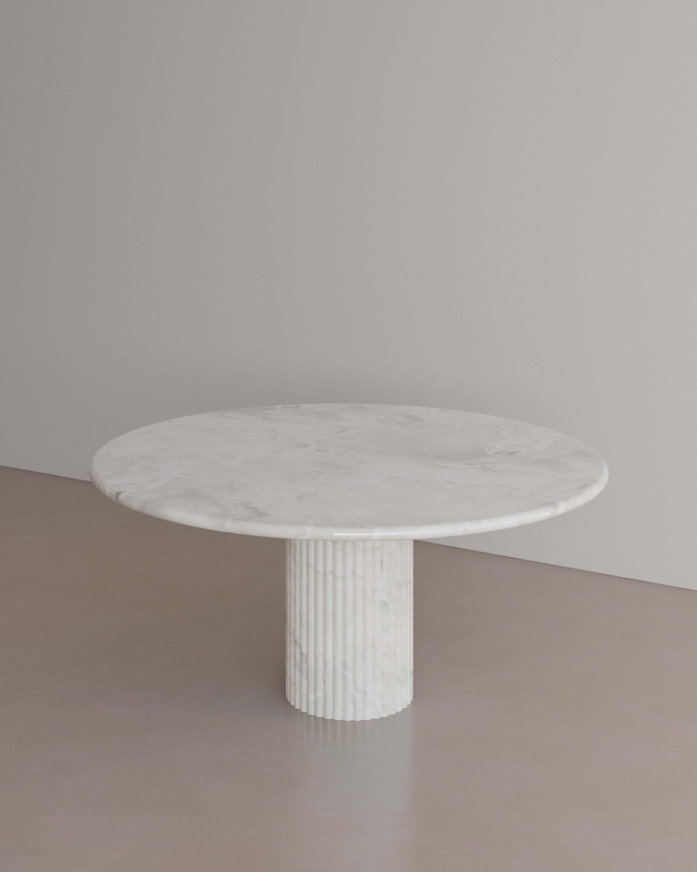The Essentialist brings you The Antica Dining Table I in Calacatta Viola Marble . An oval table top resolved by smooth bullnose edges rests on two supporting pillars. Architectural form is refined by artistic expression echoing Roman culture. This