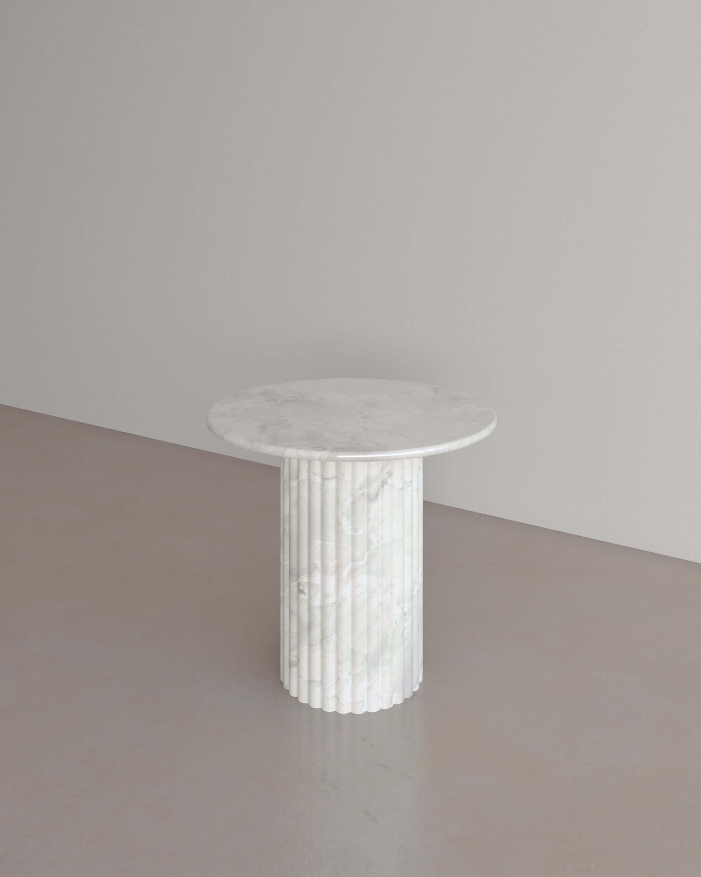 The Antica Occasional table in Bianco Onyx by The Essentialist displays a perfect synergy by viewing classical idealism through a modern lens. A traditional pillar supports a circular top with bullnose edges, crafted from whole natural stone.
The
