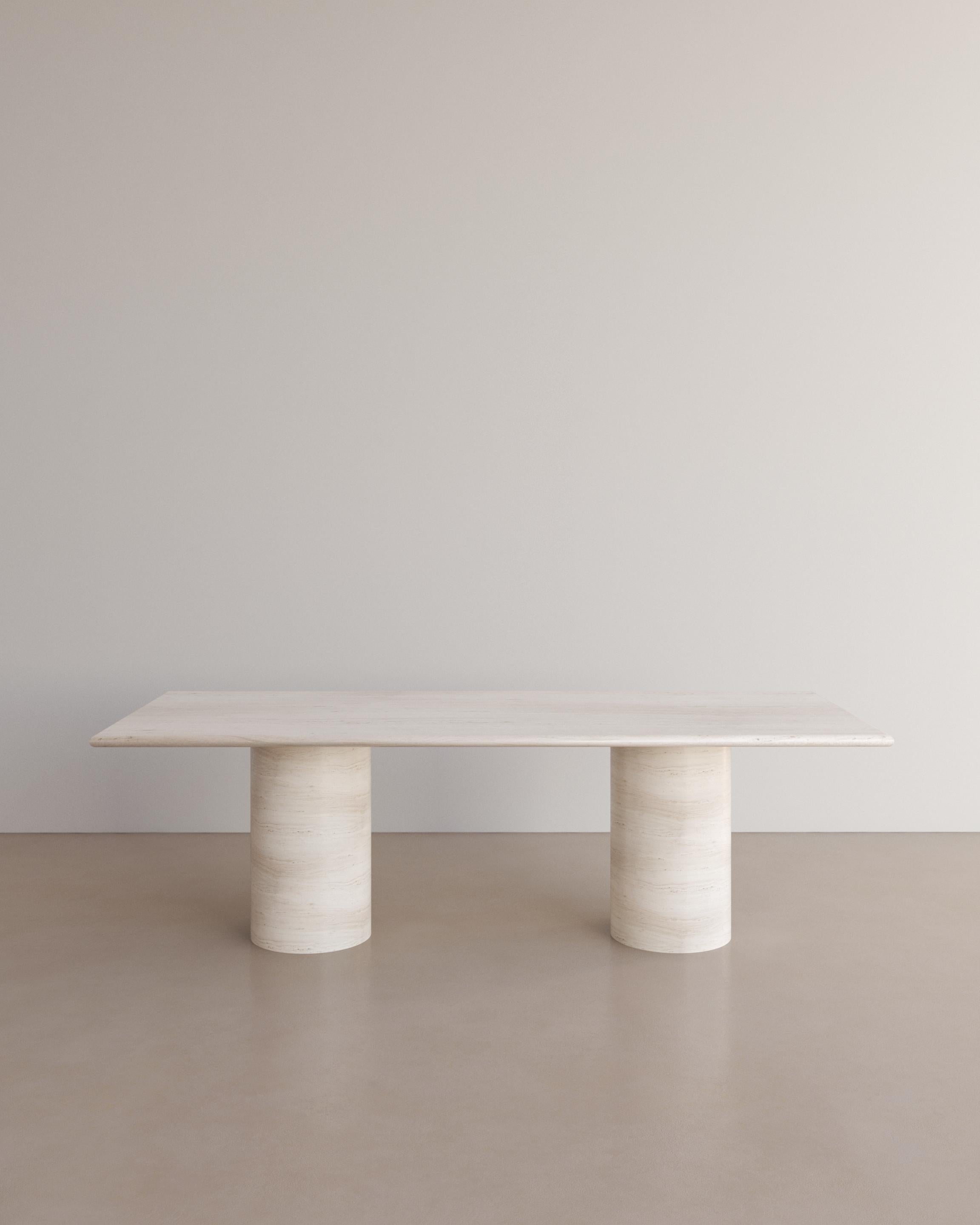 The Voyage dining table I in Bianco Travertine by The Essentialist celebrates the simple pleasures that define life and replenish the soul through harnessing essential form. Envisioned as an ode to historical elegance, captured through a modern lens