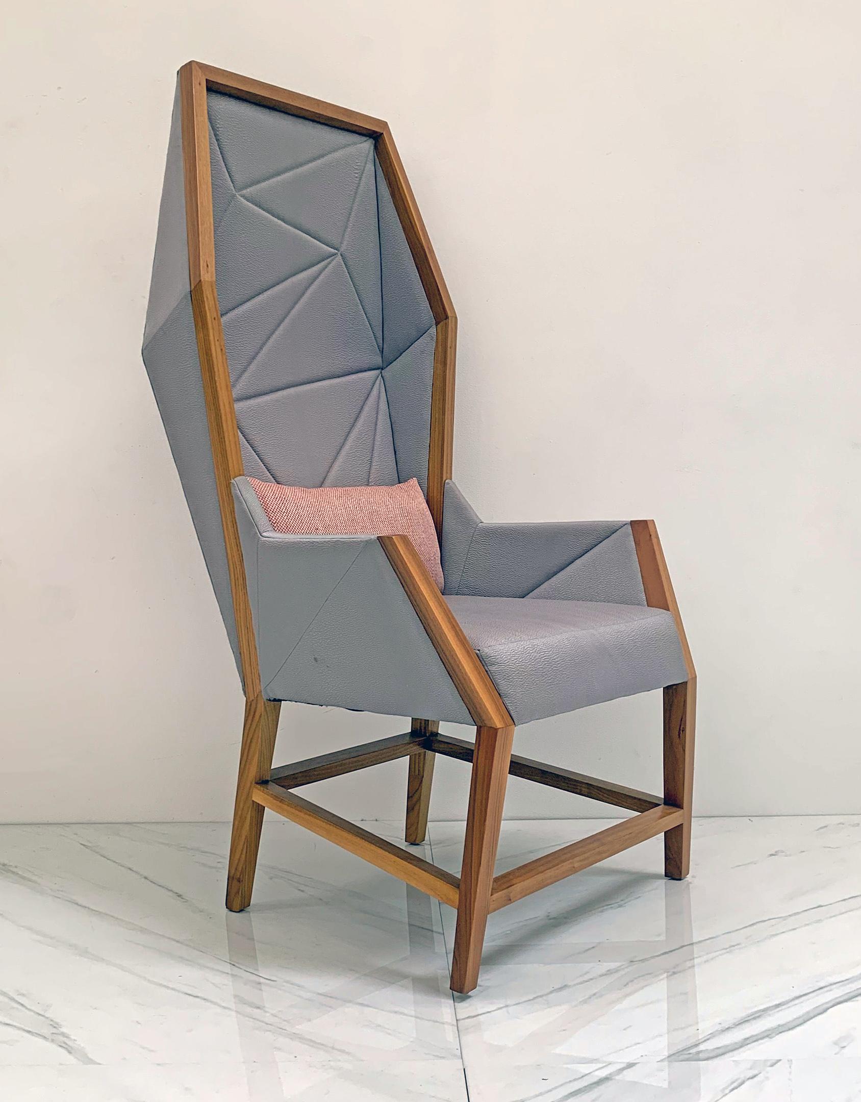 This hooded wingback chair is absolutely gorgeous! Such a statement piece! Inspired by crystalline structures with bias cut hand paneled upholstery and attractive exposed wooden frames, this elegantly modern hooded lounge chair is a not to both new
