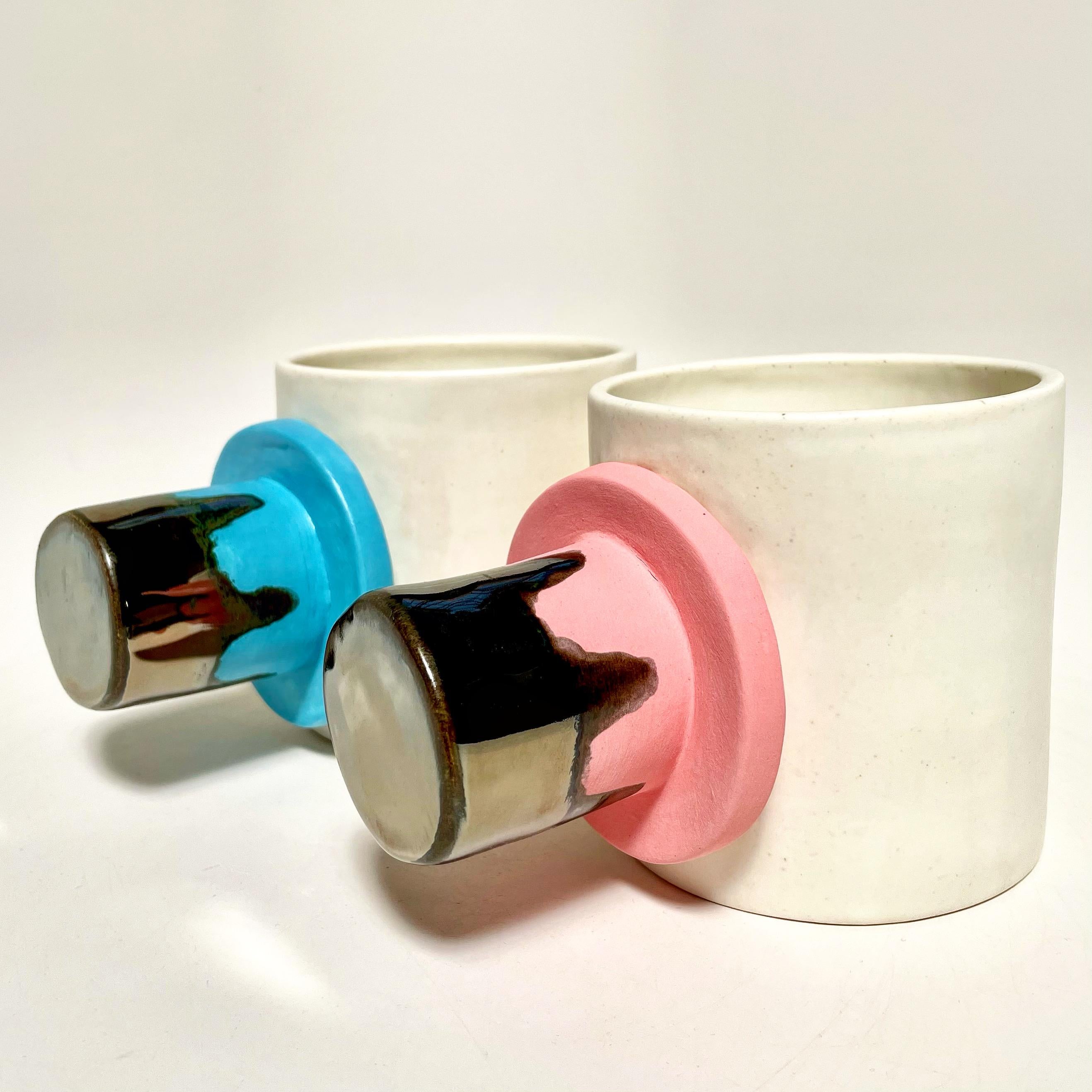 The BIB mixed handle espresso set of four, shown in turquoise and matte pink with degrade silver handles, the ideal set for your cappuccino or espresso. Perfect for entertaining, or as a set of decorative objects or object d'art. Versatile,
