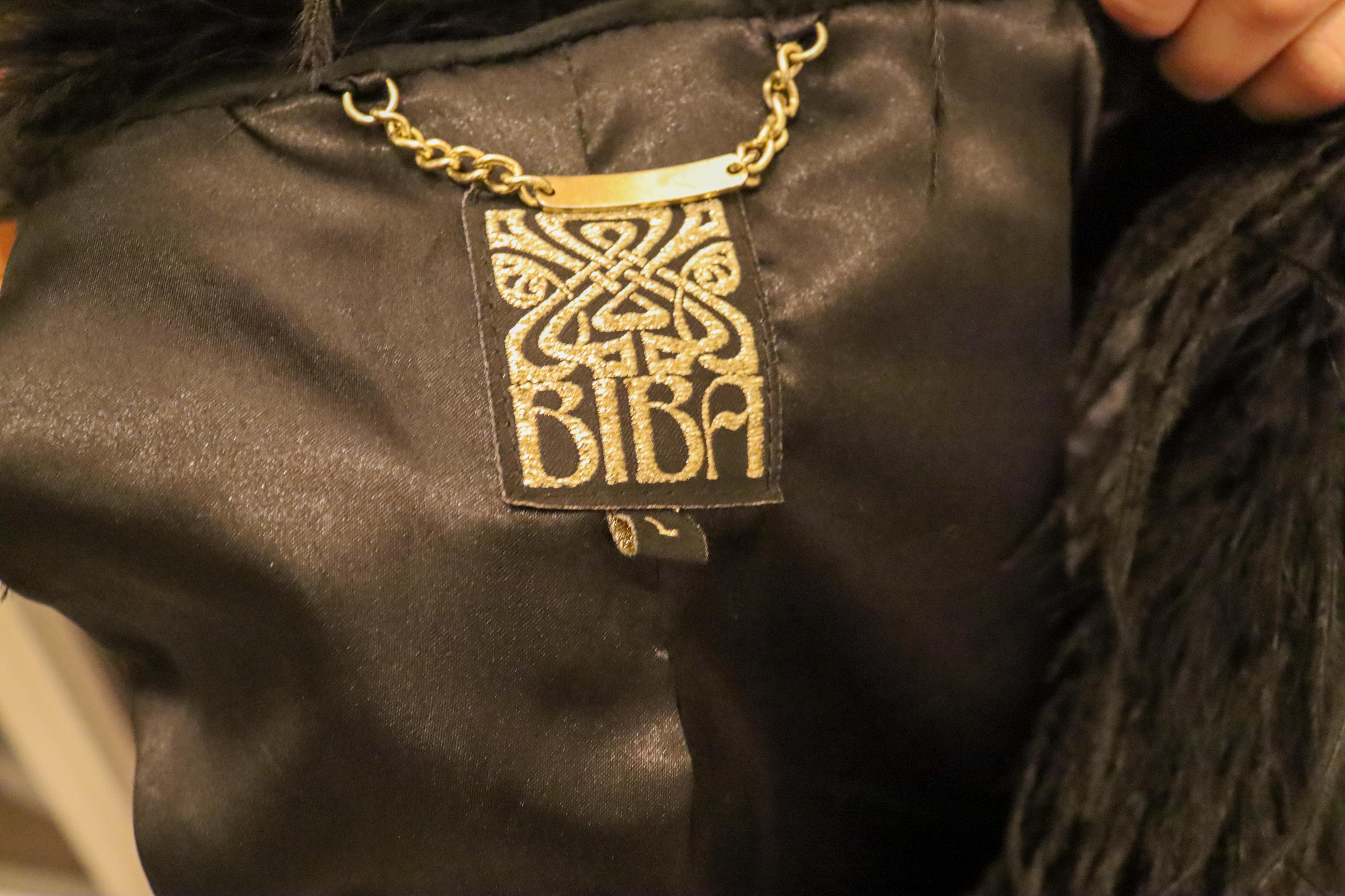 A great gilet by Biba. In black suede with attractive stitch detail on the front and back. It is trimmed in fur at the arms and front, and fully lined. 
Measurements: Bust up to 36'', length 19''. shoulder to shoulder 15''.