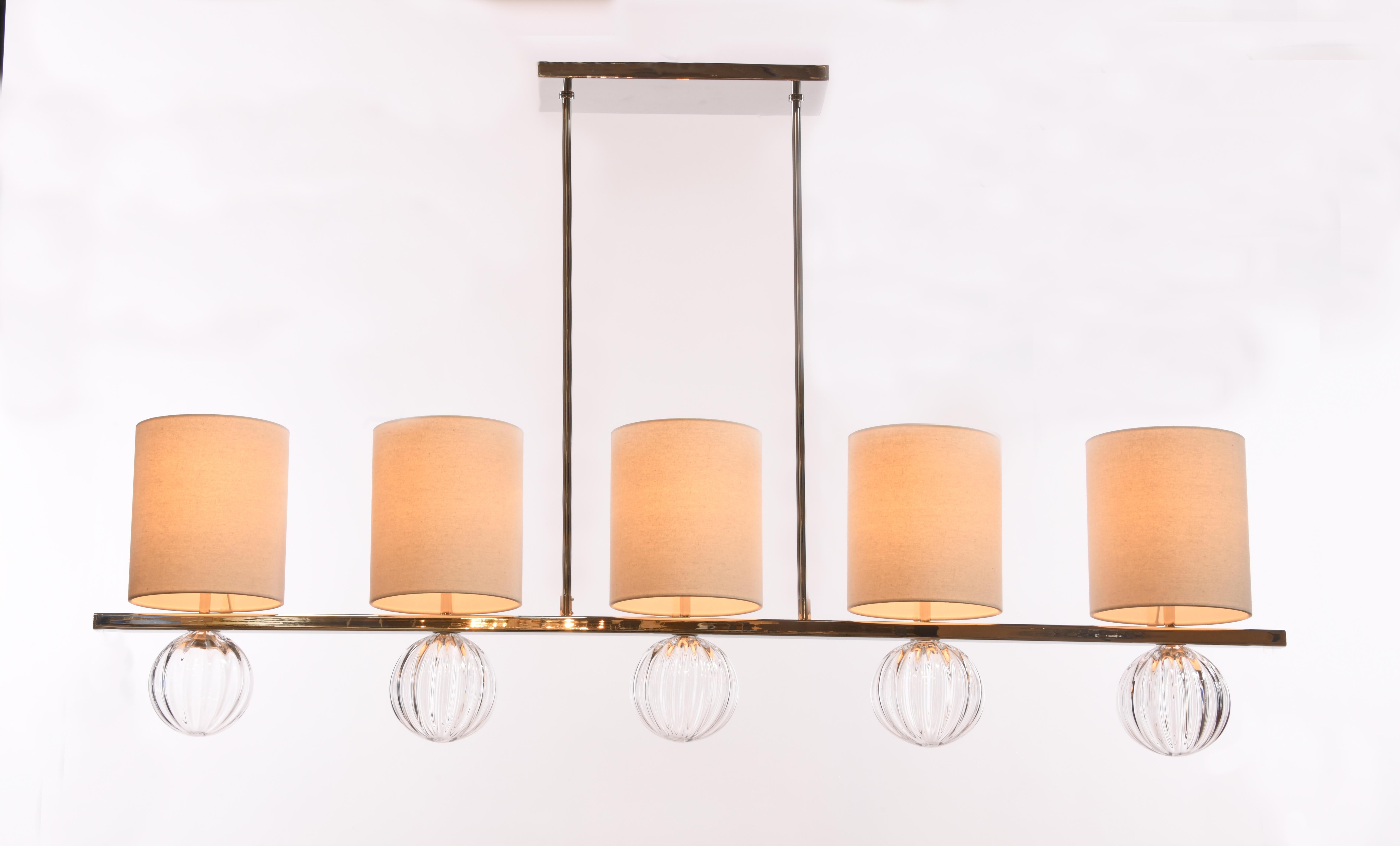 Natural linen cylindrical shade with a whimsical fluted glass detail - available in six delicious colors - balanced on a linear frame of mirrored nice nickel or bossy brass.

LUXE lighting collections are handcrafted from the finest materials,