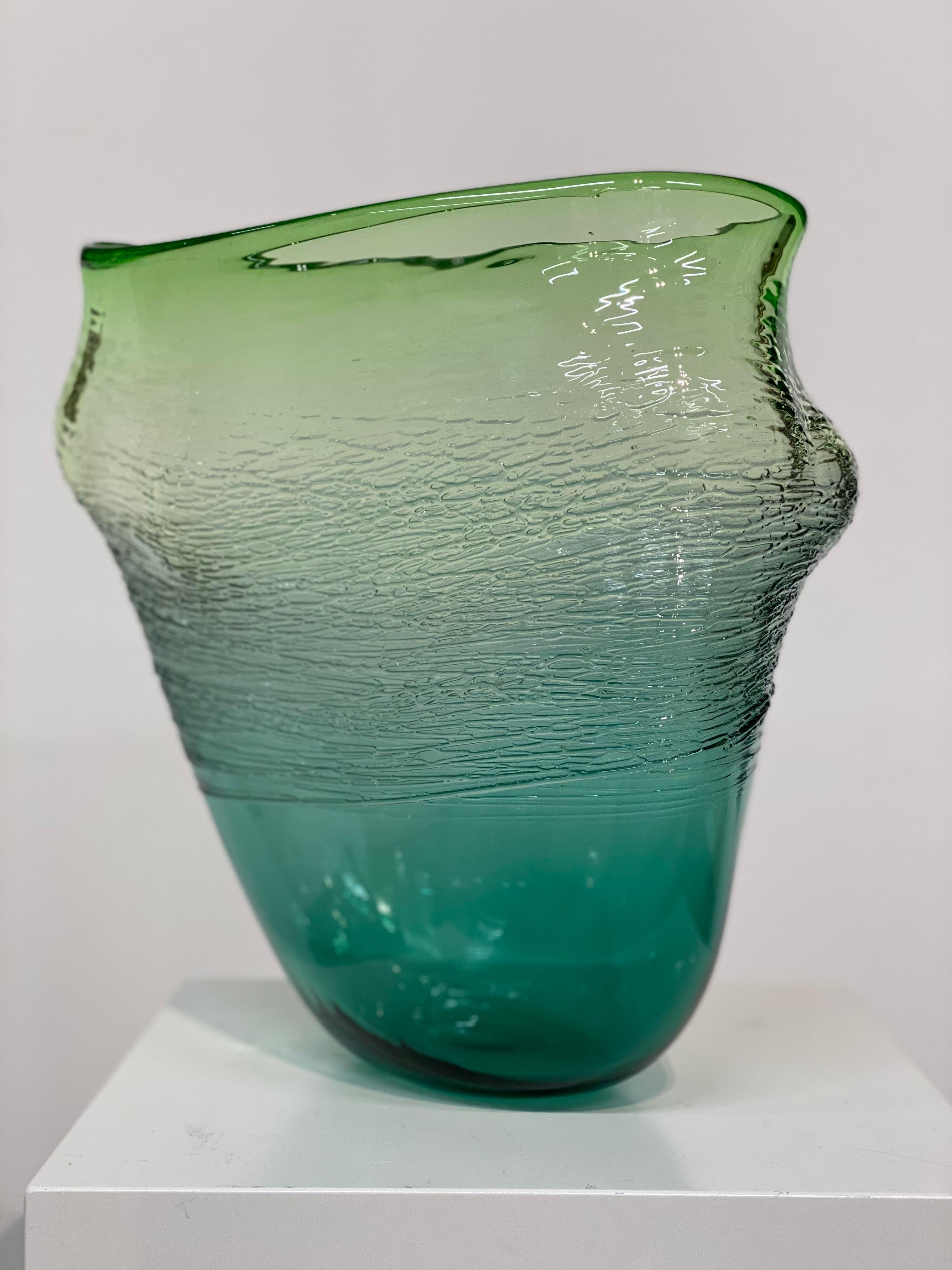 Bibi Smit
Fluid Form, green
H32cm-B25cm-D20cm 
Blown glass

Bibi Smit (b. 1965) lives and works in the Netherlands. She is a glass artist and designer. She feels the need to control all the processes, from the idea and the design to the blowing, to