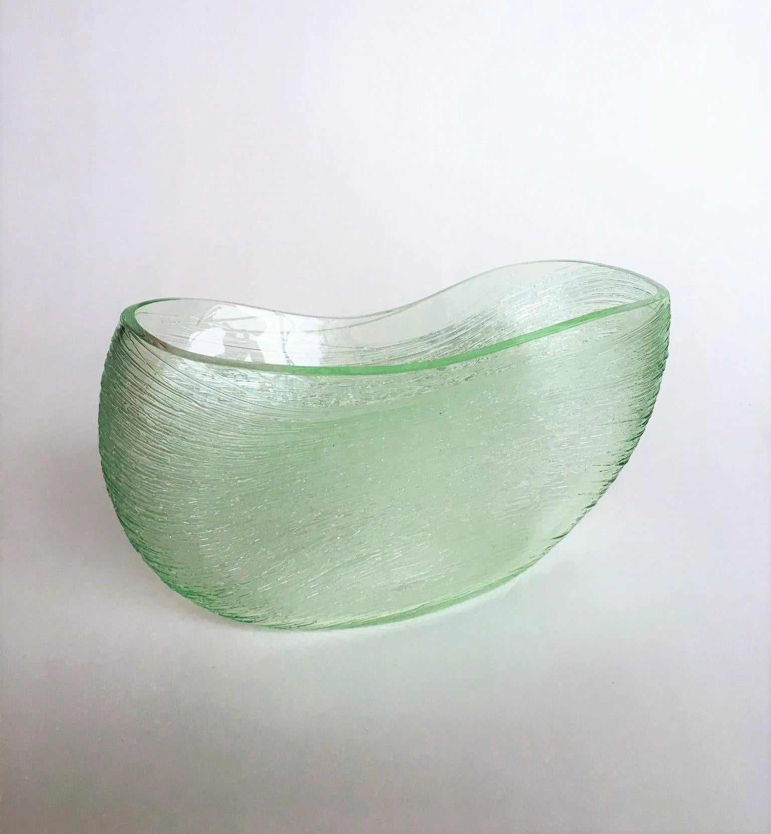 Bibi Smit
Oval Fluid Form, green
H17cm-31cm-D11 cm 
Blown glass

Bibi Smit (b. 1965) lives and works in the Netherlands. She is a glass artist and designer. She feels the need to control all the processes, from the idea and the design to the