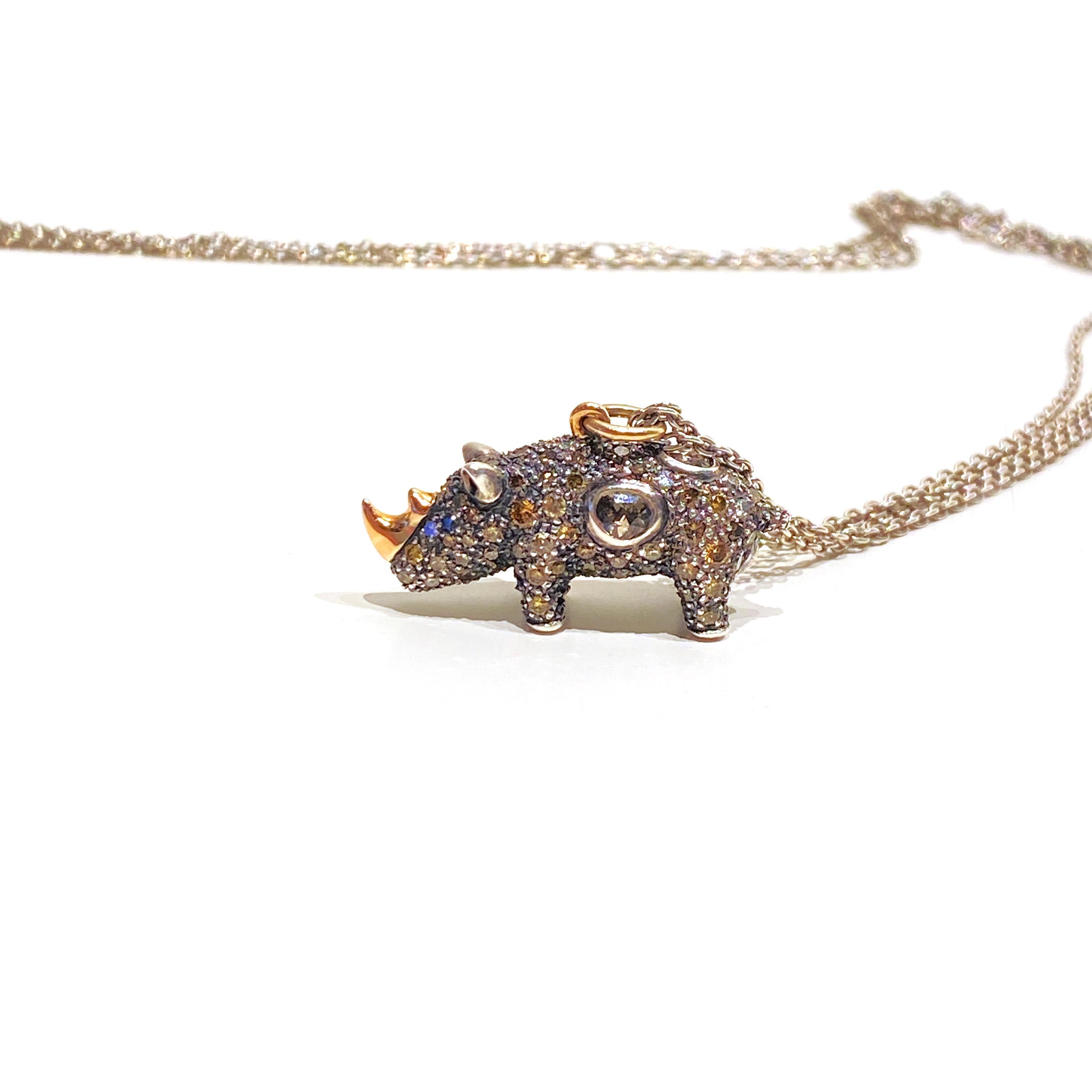 Inspired by the beauty of imperfection, Bibi van der Velden sculpts exotic materials into one-of-a-kind jewelry evoking her respect for our natural world.

This necklace has a playful rhino with brown diamonds, white diamonds, rose-cut diamonds, and