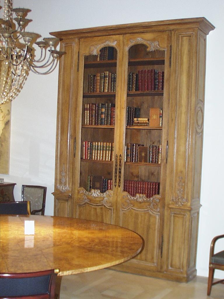 Large scale Bibliotheque in aged oak with a bleached warm oak finish, hand carved details and adjustable shelves.
