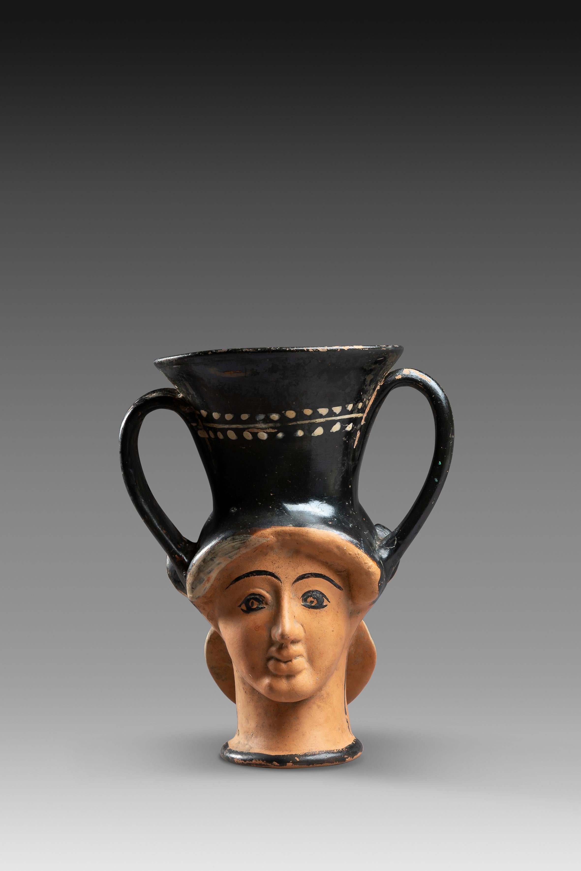 Ceramics, pigments, varnish
Athenian production dating from the beginning of the 5th century BCE.

A bicephalous kantharus with molded faces on the paunch: a maenad and a silene. The natural color of the terracotta is preserved on the two faces,