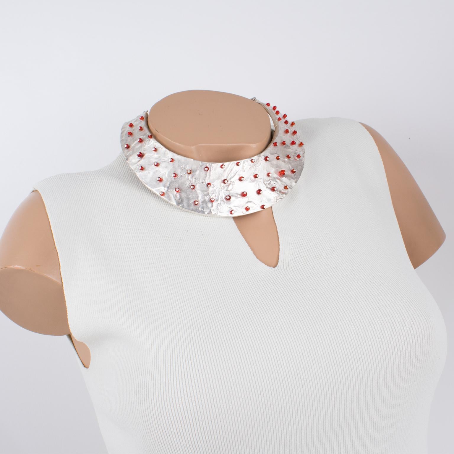 Nelly Biche de Bere, Paris, designed this stunning modernist silver plate rigid collar necklace in the 1990s. The chunky massive shape features a brutalist carved and hand-made feel design, topped with tiny ruby red glass beads, randomly displayed.