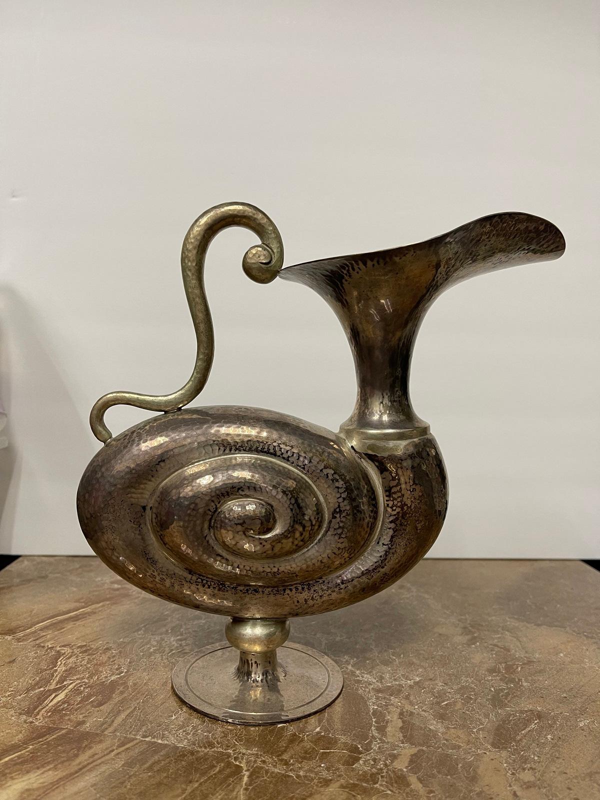 Vintage and unique Pampaloni Bichierografia  – “snail” pitcher in sterling silver. 
Large size pitcher - height 8.25 inches and width 7 inches.
Retail price: $3,900
Our price: $1,900
Pre-owned.
Before shipment, we will include final cleaning and