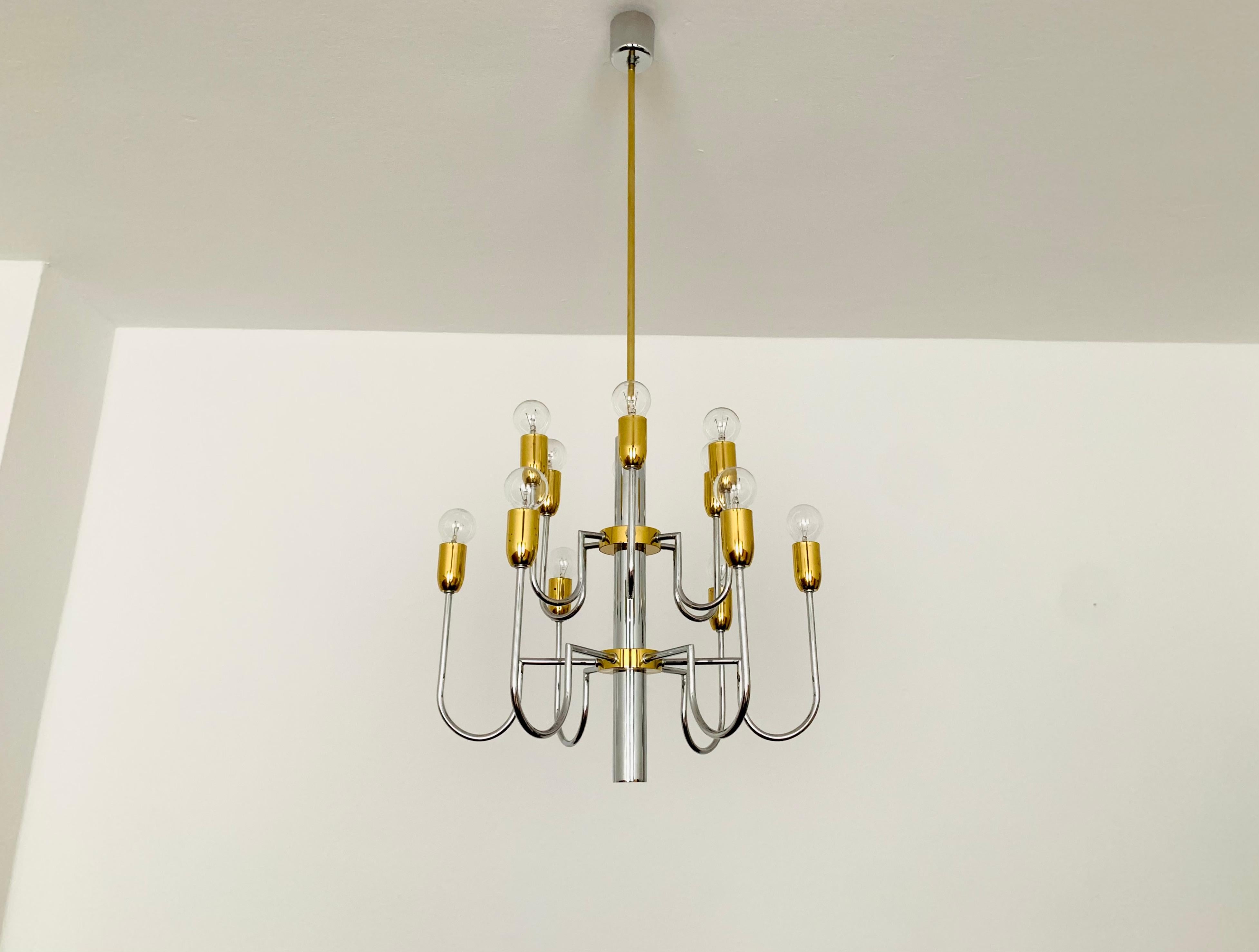 Impressive Holywood Regency chandelier from the 1970s.
The lamp looks very noble and elegant due to the two-tone design.
Impressive contemporary design and an asset to any home.
An exciting, sparkling play of light is created in the