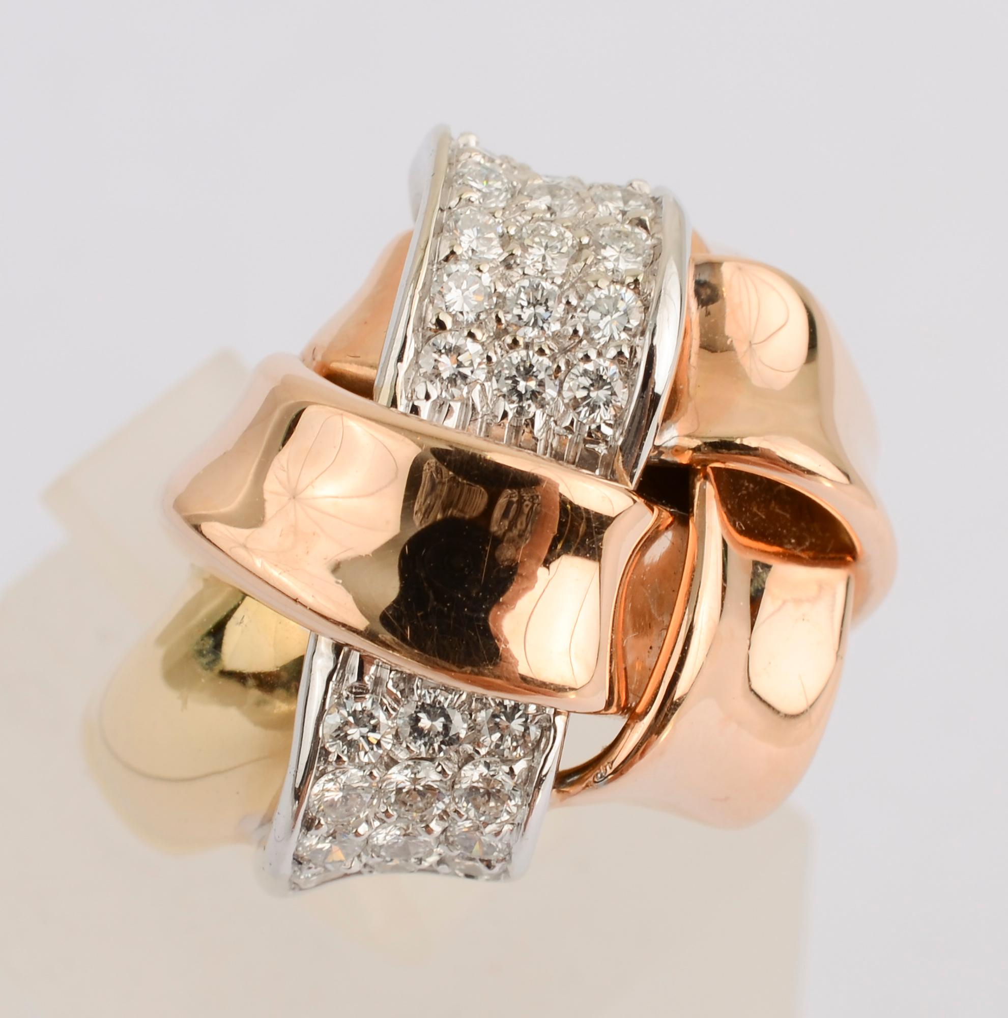 Substantial gold and diamond ring in which bands of gold are interlaced with one of diamonds. The shank of the ring is yellow gold and the lattice bands are rose gold. The ring is size 7 3/4.   It can easily be sized up or down. While acquired