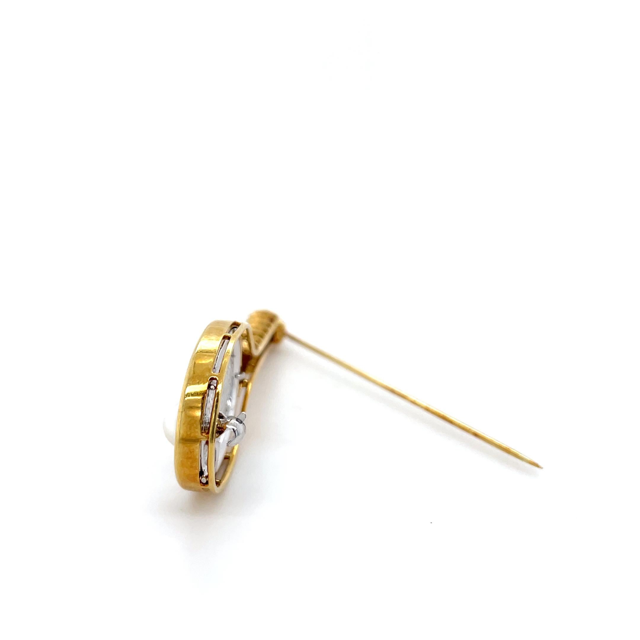 This playful tennis racquet brooch is decorated with 24 top quality round brilliant cut diamonds weighing approximately 0.75 carat total with a cultured pearl 