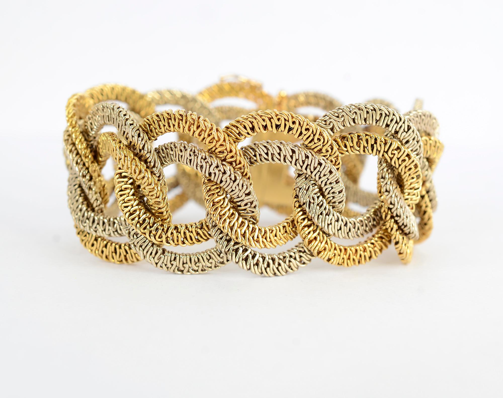 Yellow and white gold bracelet of undulating double links. Each link is made up of very intricately intertwined tiny loops creating a beautiful texture.
The bracelet has a wearable length of 7 3/4 inches. The links are 1 1/8 inches wide. The