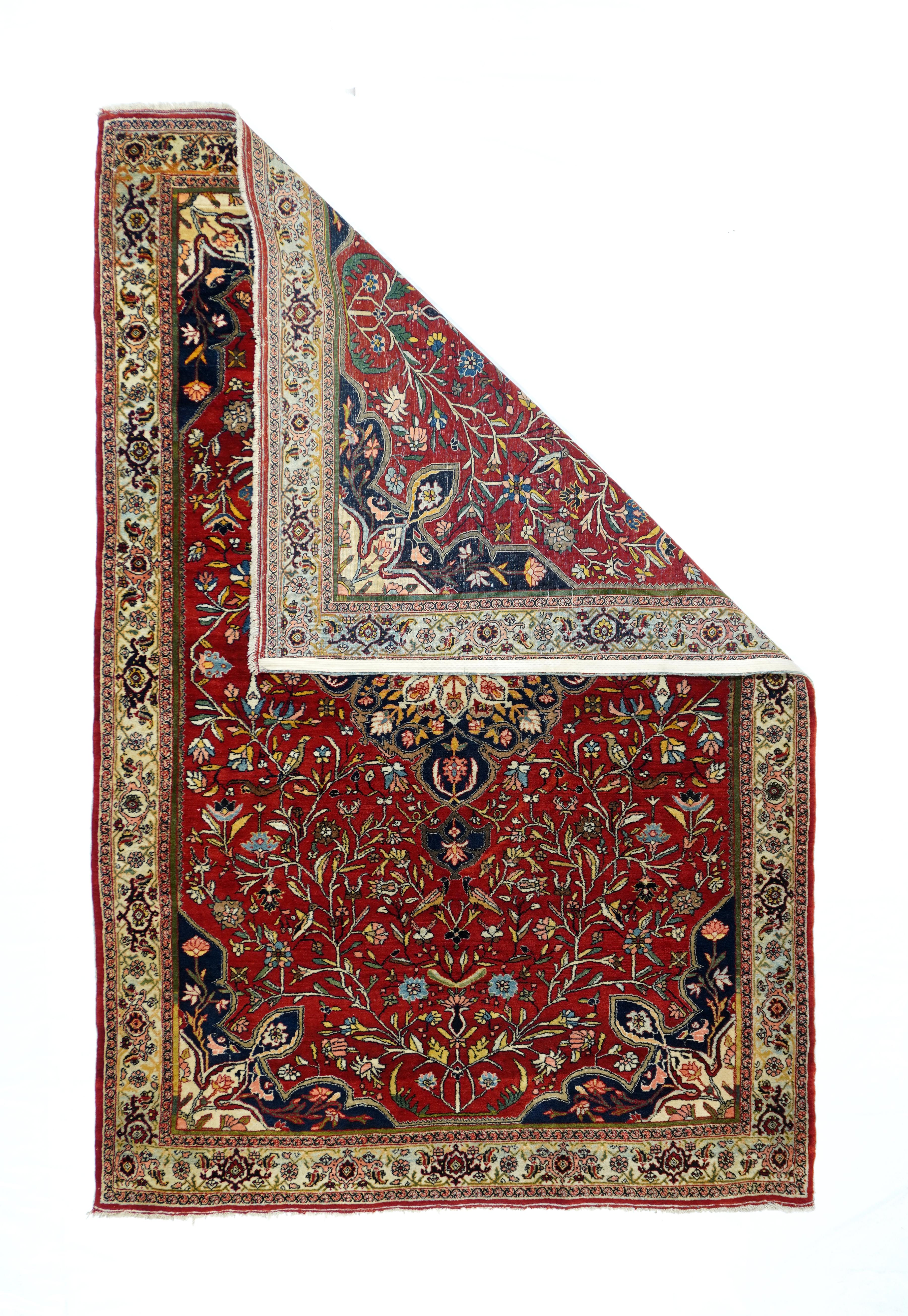 This robust urban Kurdish scatter displays a saturated red field centred by a layered navy and ecru octilobe medallion with radiating internal flowers. Stems vigourously grow from 