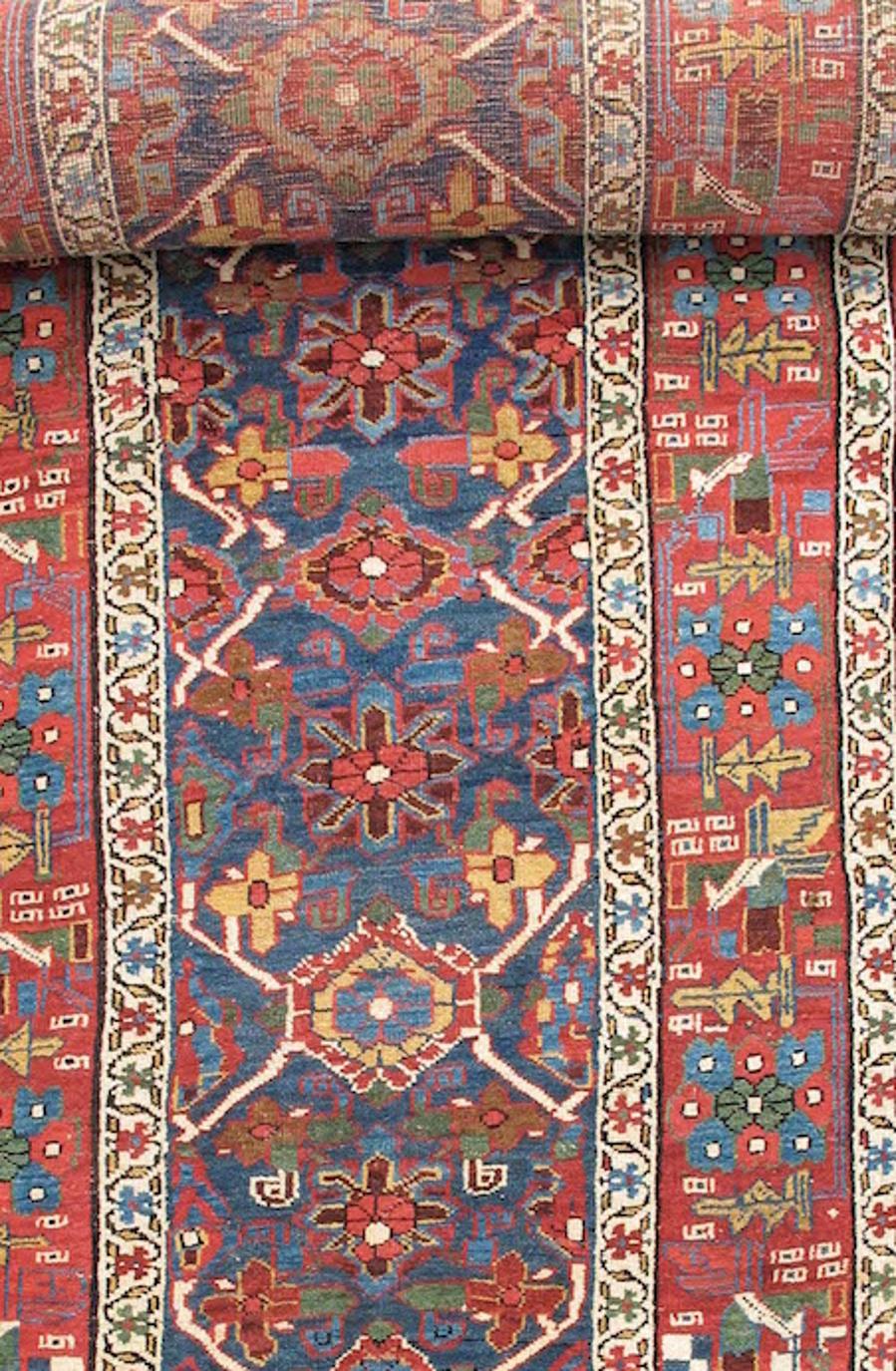 This colorful Bidjar runner uses a classic floral ‘mina khani’ design. The ‘mina khani’ pattern is usually characterized by large alternating floral buds interspersed with a row of smaller flanking jasmine flowers. During the nineteenth-century it