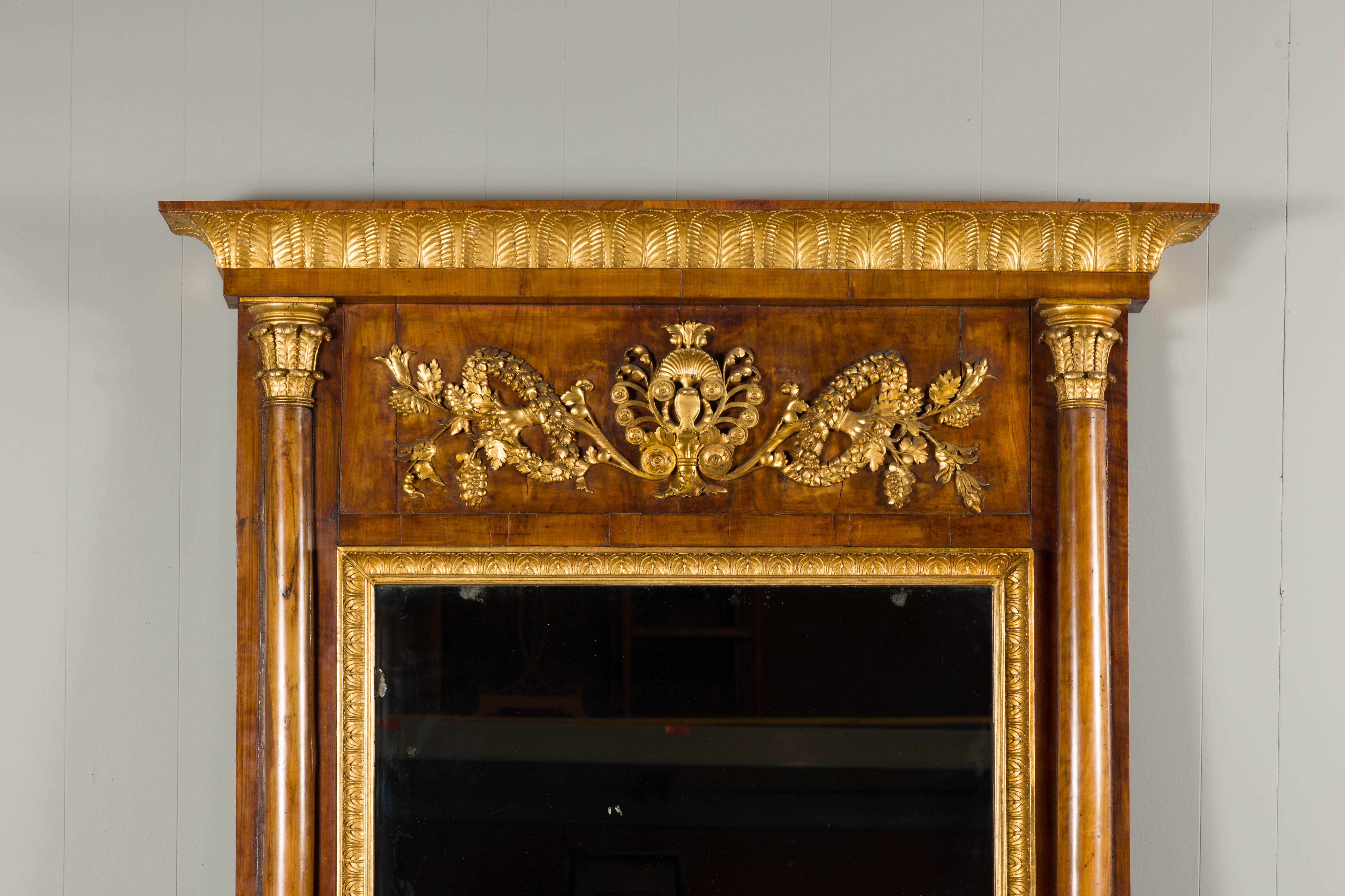 Austrian Biedermeier 19th Century Tall Walnut Mirror with Carved Giltwood Foliage Motifs For Sale