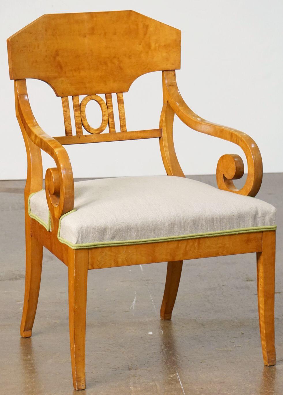 A fine pair of Biedermeier armchairs or desk chairs of beautifully patinated satinwood, from Sweden circa 1840 - each chair featuring an elegantly shaped back and scroll arms, with a comfortable recently reupholstered seat in a neutral linen with