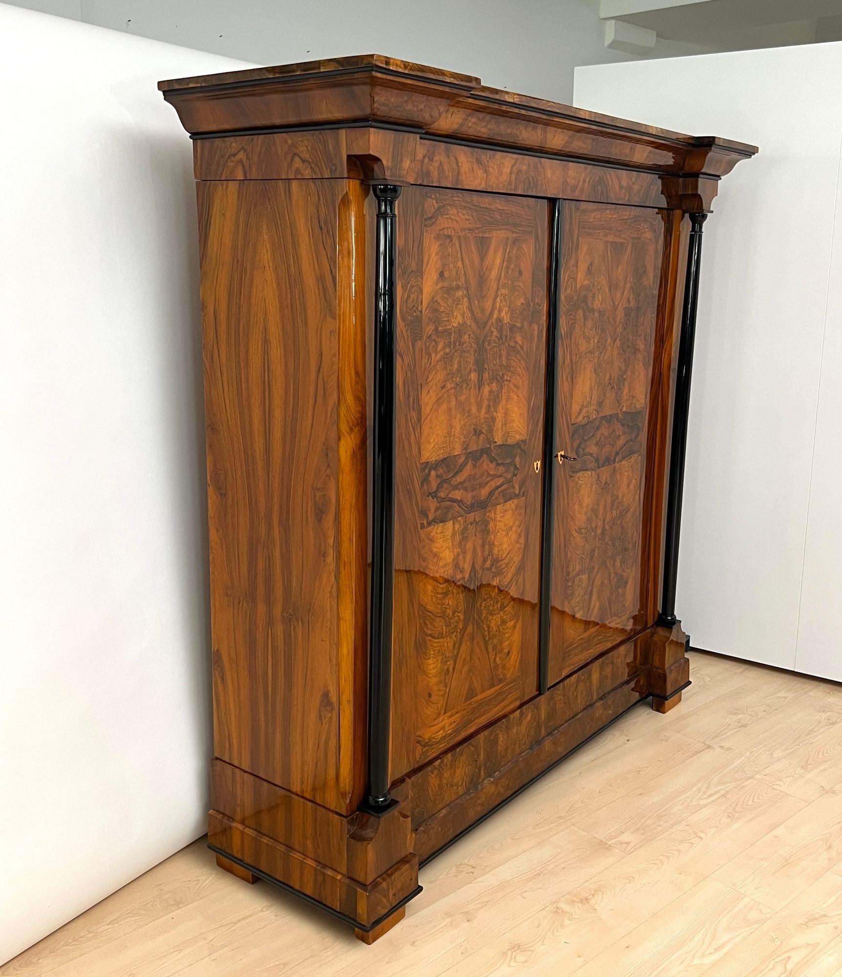 Imponente armadio o guardaroba Biedermeier di grandi dimensioni proveniente dalla Germania meridionale, circa 1820.
Splendida impiallacciatura in noce e radica di noce su legno dolce. Colonne piene e finiture intermedie ebanizzate.
Bellissimo