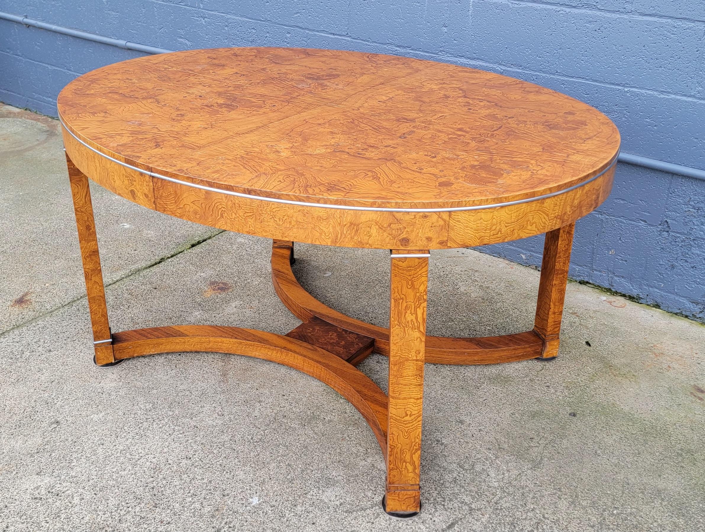 Exotic burl wood expanding oval dining table designed in the style of Biedermeier furniture and/or French Art Deco. Circa. 1950's. Beautiful book-matched burl wood grain. Includes two 13.13