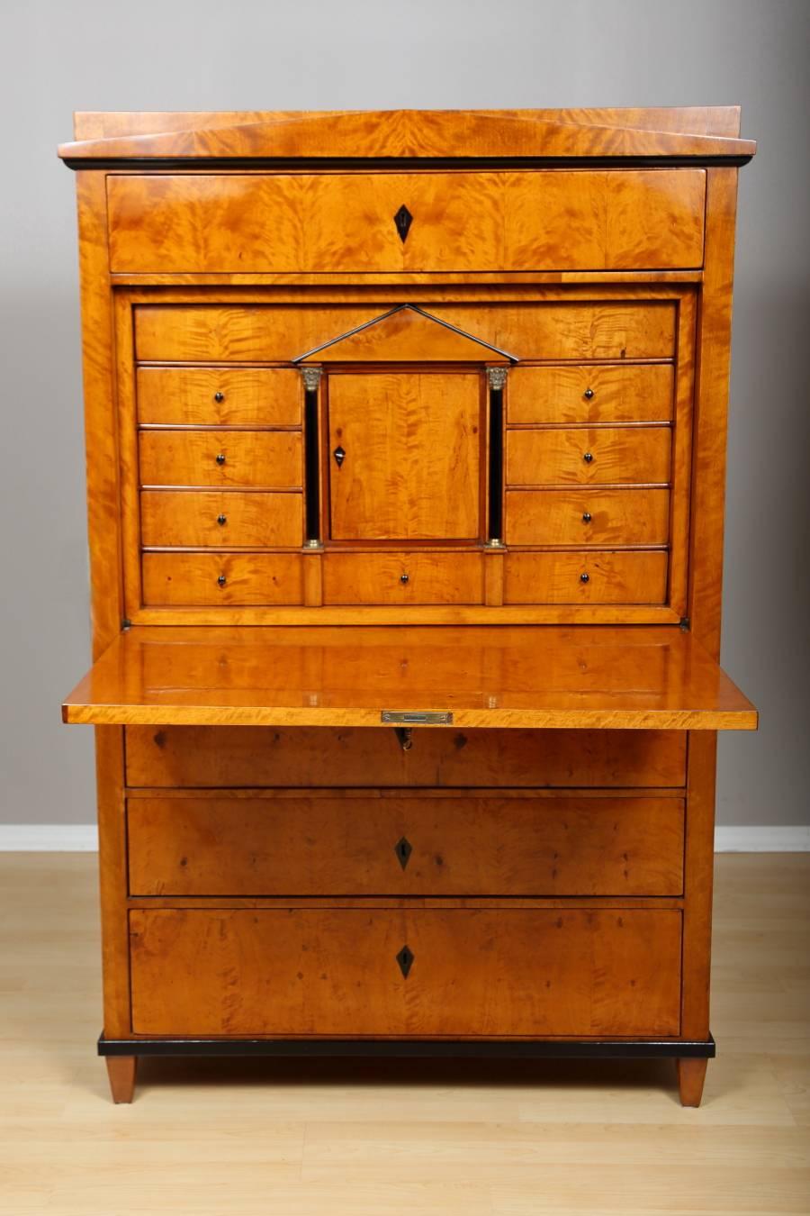 Biedermeier Birch Secretaire, circa 1820. This elegant secretary, handcrafted in Germany, features three large drawers at bottom, and one large drawer above the fall front surface. The interior of the fall-front reveals several smaller drawers