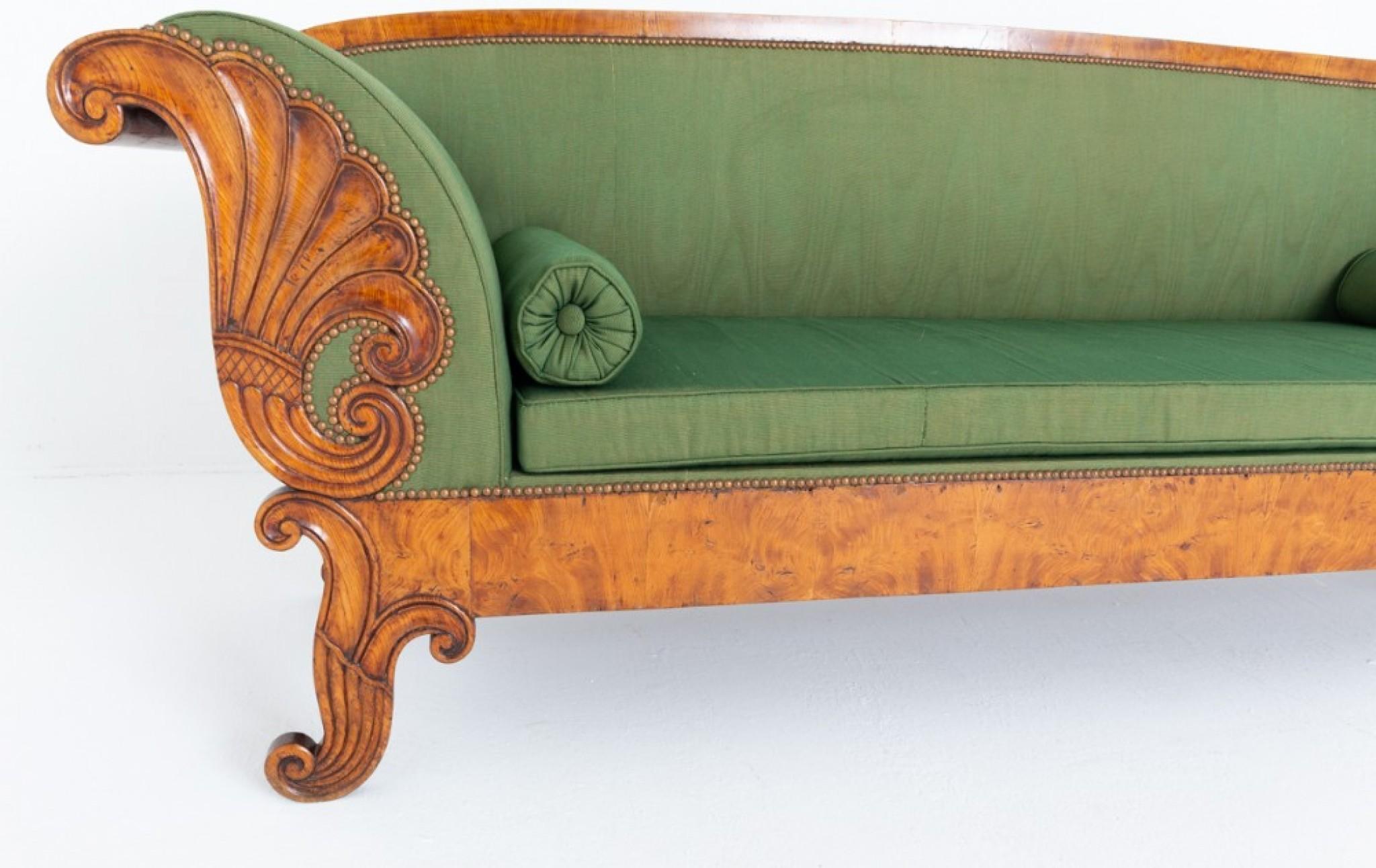 Amazing large Scandinavian Biedermeier style birch sofa.
Circa 1860
Raised upon carved and shaped legs.
The front of each arm carved with a cornucopia decoration.
The sofa is upholstered in a green fabric and comes complete with bolster