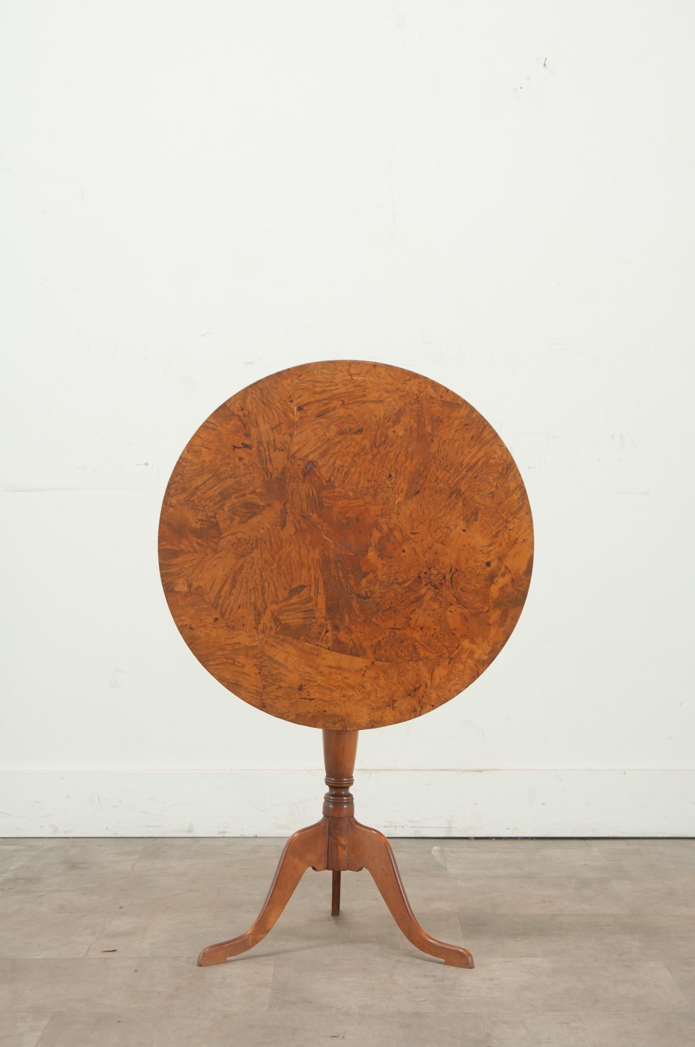 A 19th Century Swedish tilt-top table made of birch wood. The burl birch circular top rests over a pedestal base with three splayed legs. Cleaned and polished with a French paste wax this antique is ready for your immediate use. Be sure to view the