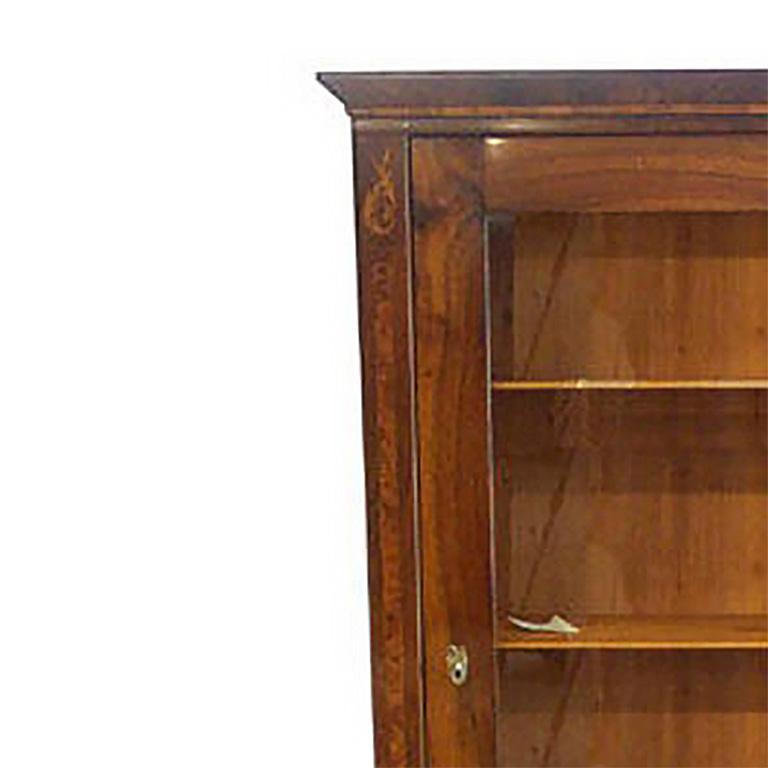 Biedermeier Bookcase in Walnut and Birdseye with large glass door. Interior shelves above a single drawer.