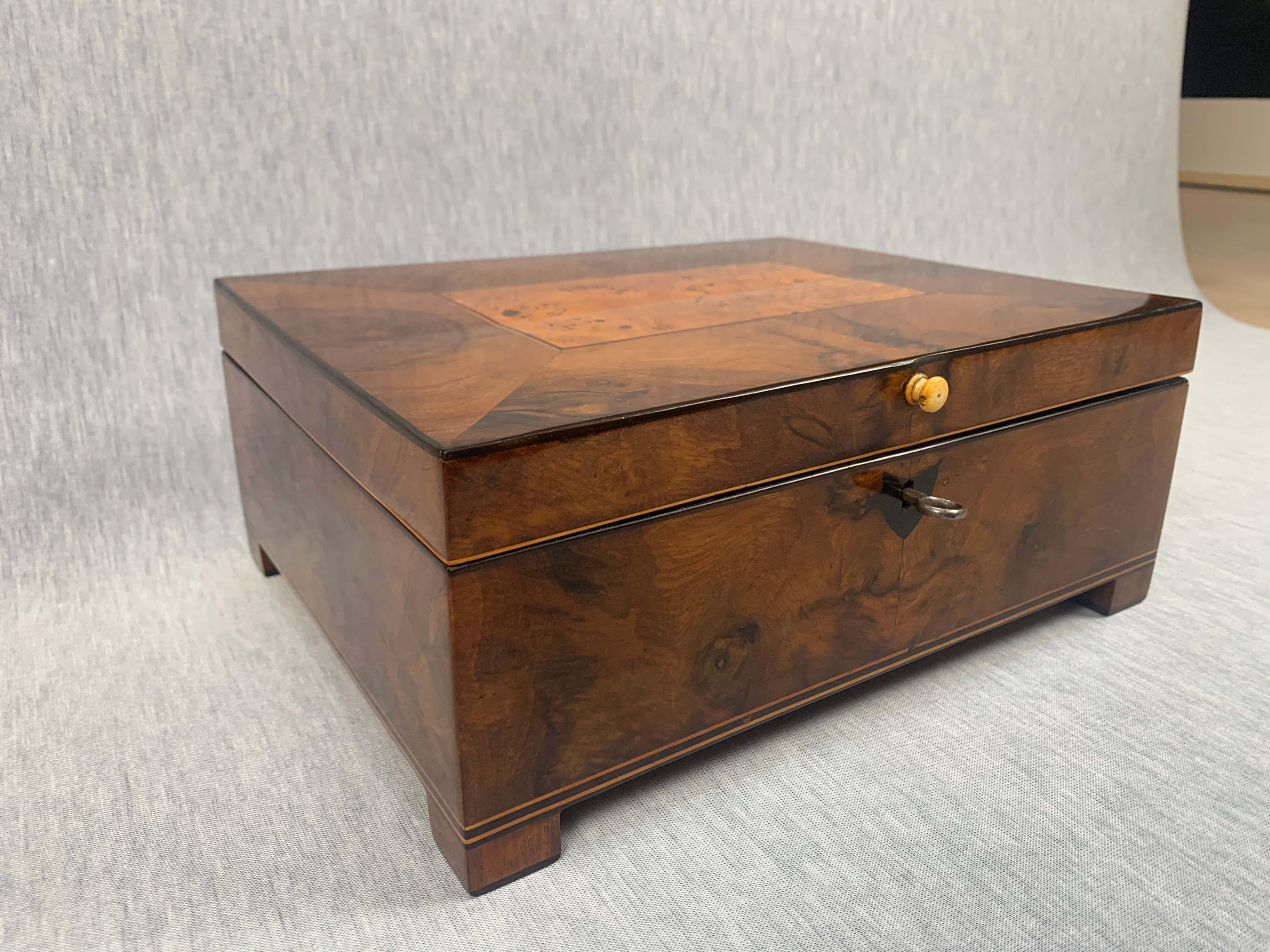 Very fine neoclassical Biedermeier casket box with full interior from Austria / Vienna, circa 1820.

Elaborately done sewing / casket / jewelry box, thick walnut veneer on cherry solid wood. Lid with central birch root inlay.
Ebony and maple