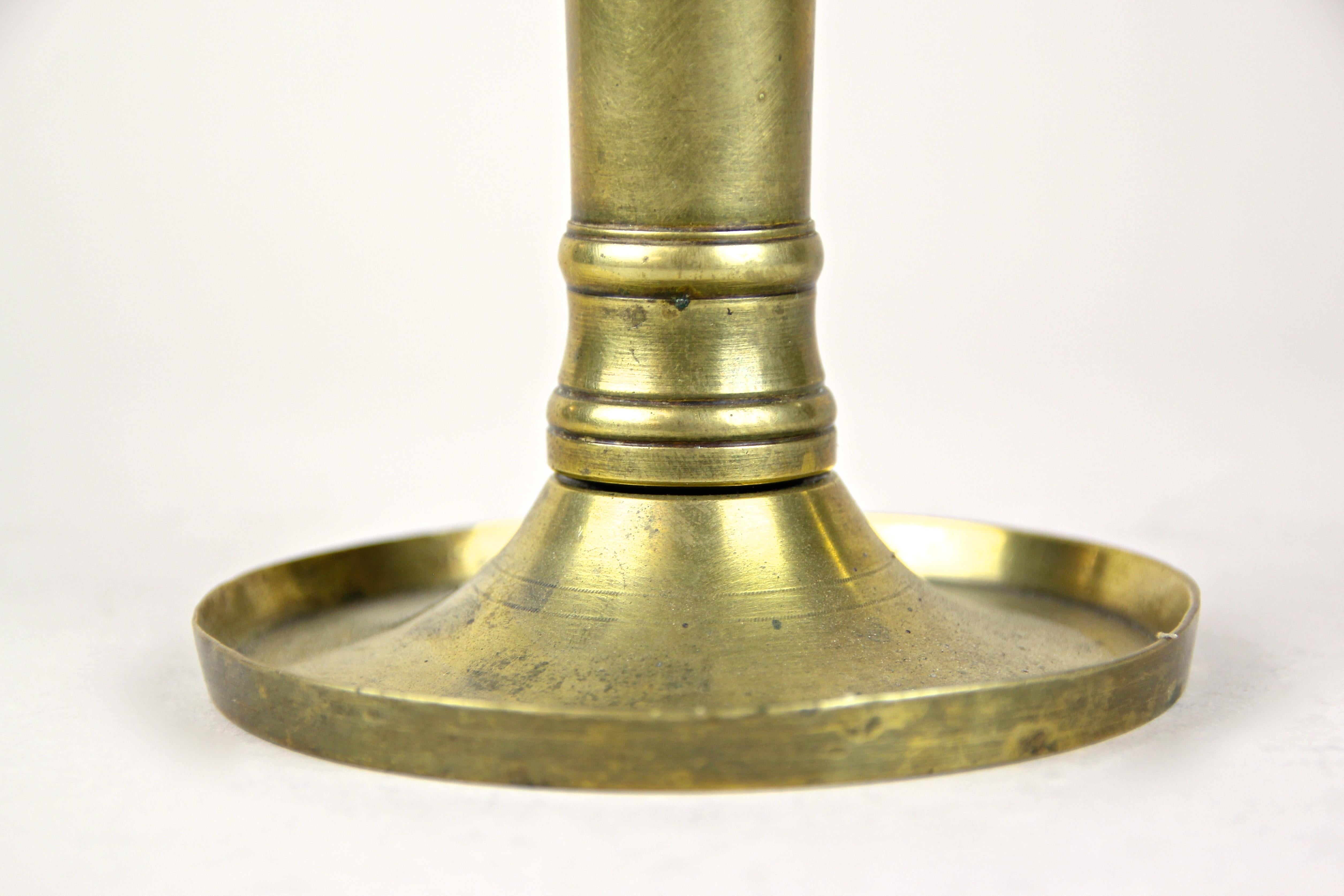 Decorative 19th century Austrian Biedermeier brass candlestick from circa 1830. A straight, clear shape, a typical attribute for the early Biedermeier period, processed of fine brass with nice details, makes this antique candlestick a very
