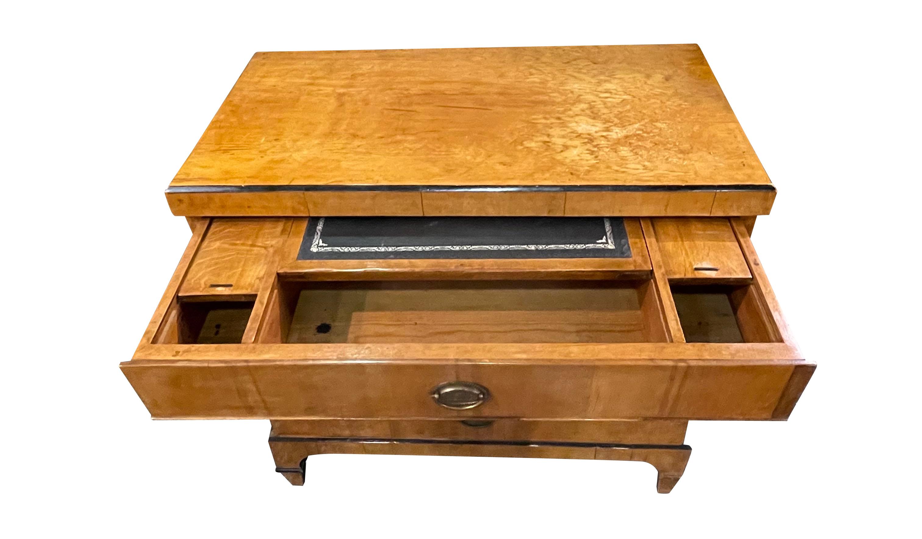 19th Century Austrian Biedermeier three drawer commode with top drawer pullout desk top.
Sliding black leather writing surface with two sliding hidden compartments.
Unusual semi circle designed fascade.
Signature ebonized trim detailing.
Burled