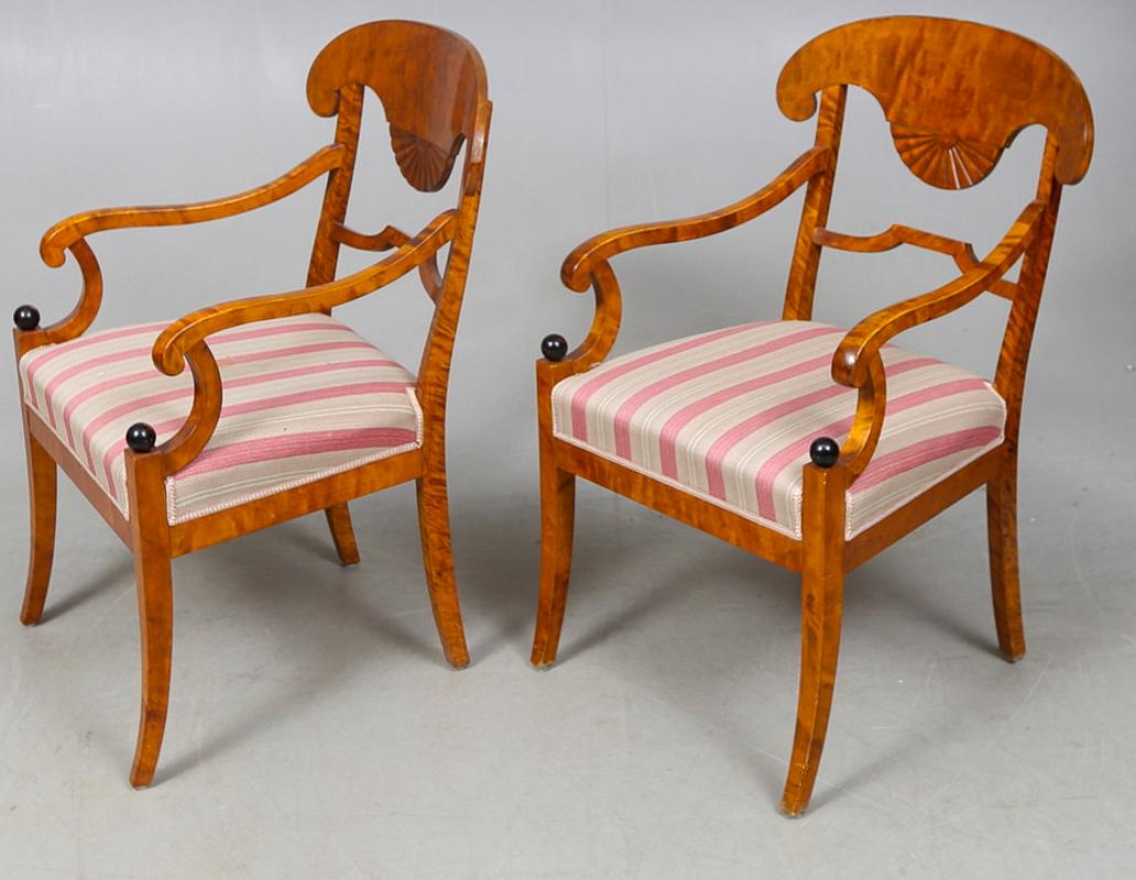 Swedish Biedermeier Empire pair of beautiful carver chairs in highest grade quilted golden birch veneers finished in the Classic honey color French polish finish with ormolu roundel on the arms and fan motifs in the seat back.

They have fully