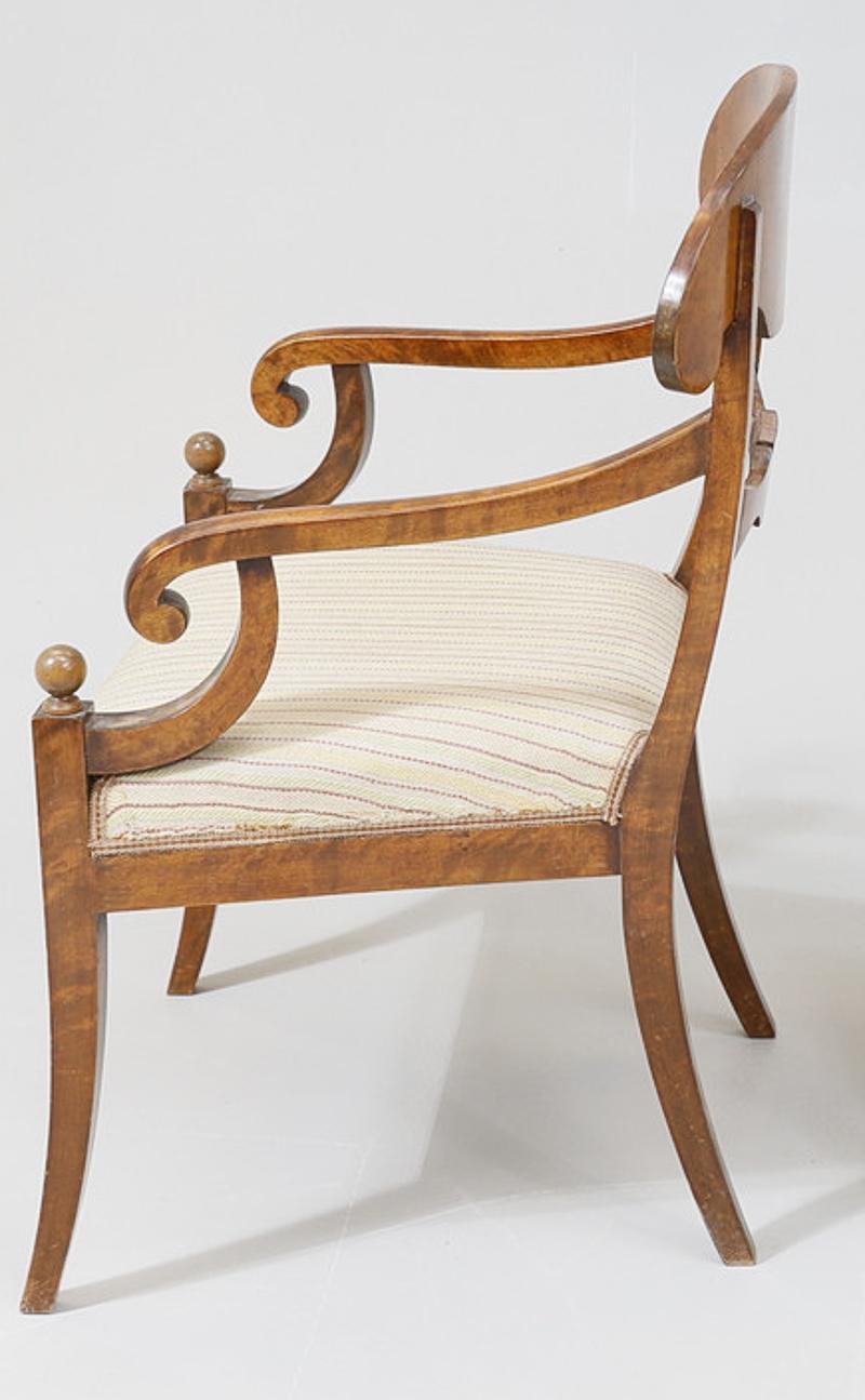 Swedish Biedermeier Empire pair of beautiful carver chairs in highest grade quilted golden birch veneers finished in the Classic mid oak color French polish finish with roundel motifs on the arms.

They have fully webbed seats for maximum comfort