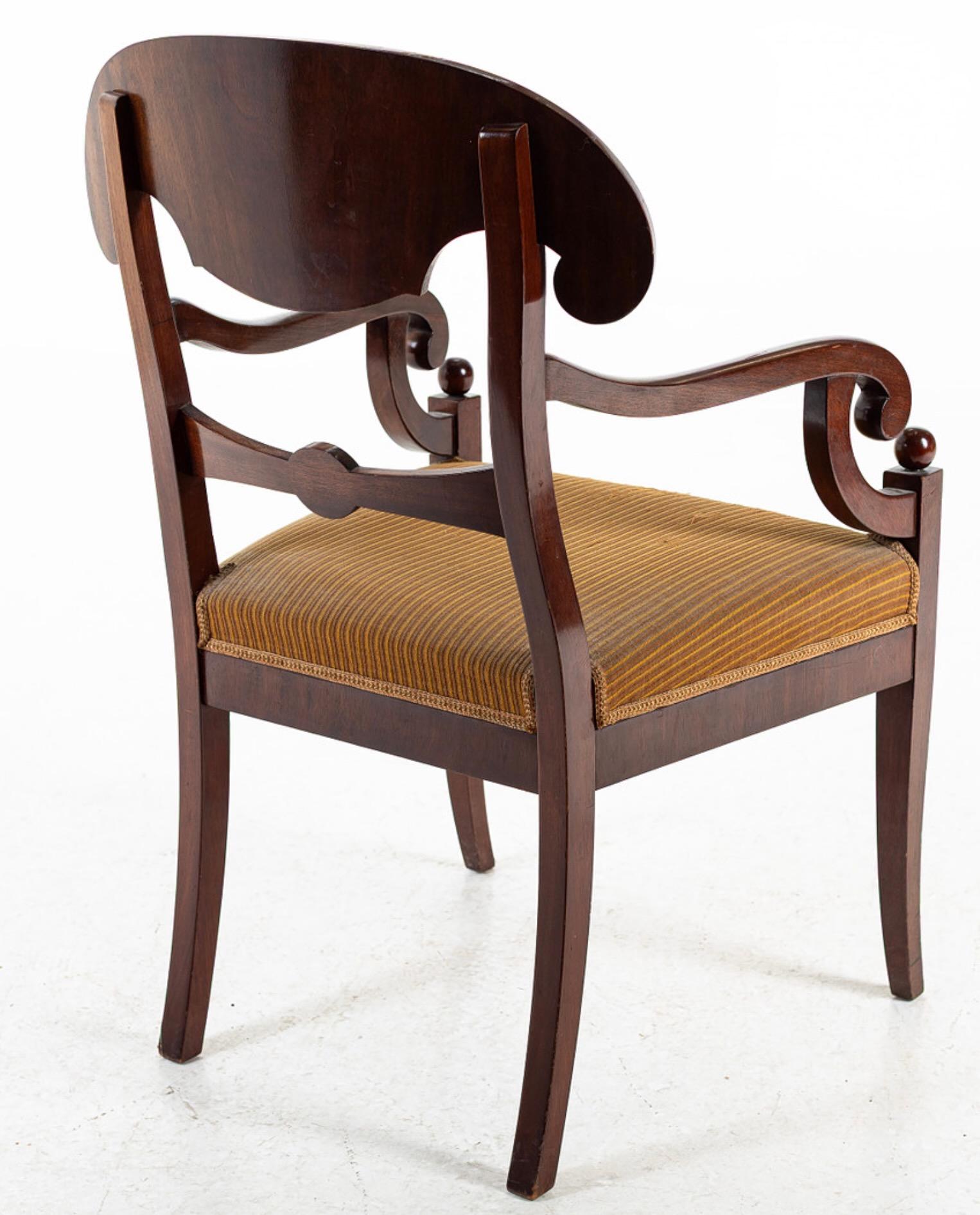 Swedish Biedermeier Empire pair of antique carver chairs in highest grade quilted golden birch veneers finished in a darker oak color French polish finish with rounded arms.

They have fully webbed seats for maximum comfort and the gently curved