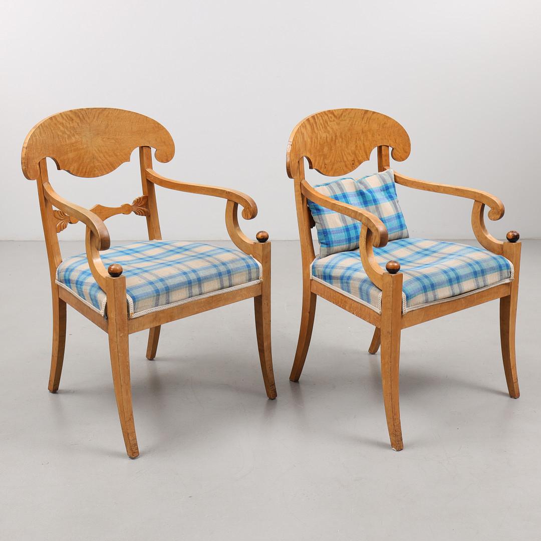 Swedish Biedermeier Empire pair of antique carver chairs in highest grade quilted golden birch veneers finished in the Classic honey oak color French polish finish with rounded arms.

They have fully webbed seats for maximum comfort and the gently