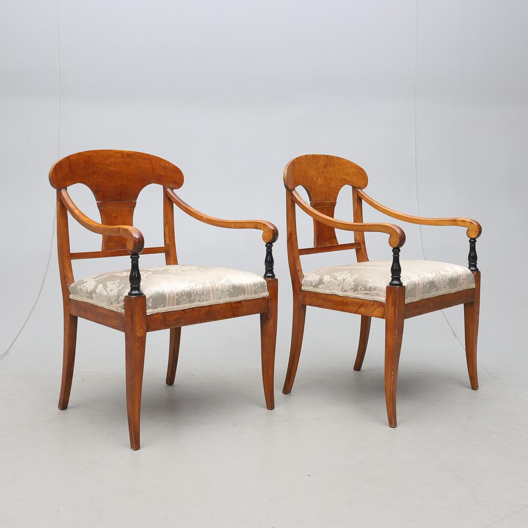 Swedish Biedermeier Empire pair of antique carver chairs in highest grade quilted golden birch veneers finished in the Classic honey oak color French polish finish with rounded arms.

They have fully webbed seats for maximum comfort and the gently